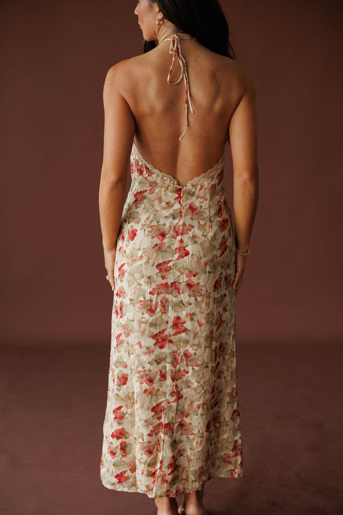 Antique Bloom Halter Dress in antique rose, back view on model with hair over one shoulder