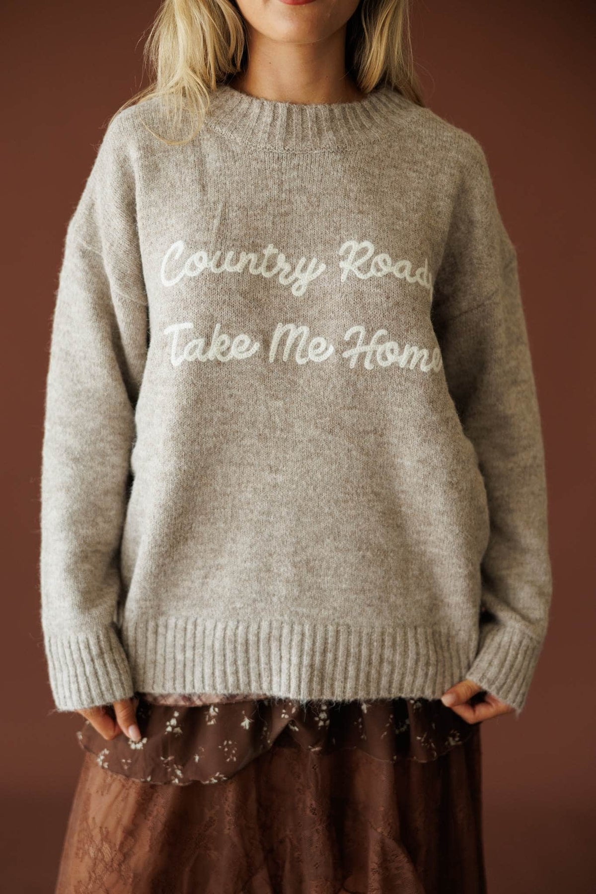 Country Roads Sweater in taupe, front close-up of the embroidered Country Roads Take Me Home script