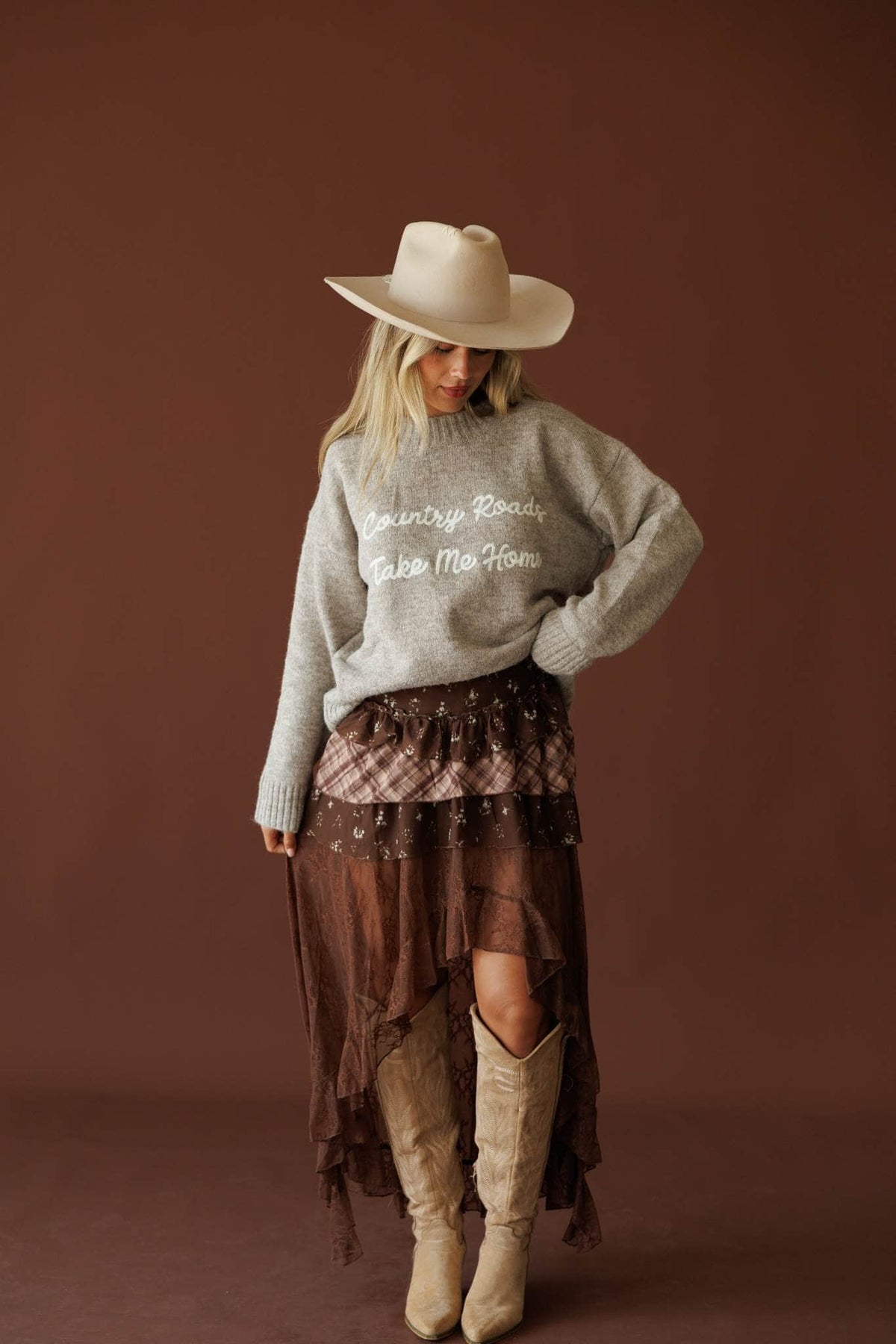 Country Roads Sweater in taupe, full-length view on model with tall boots