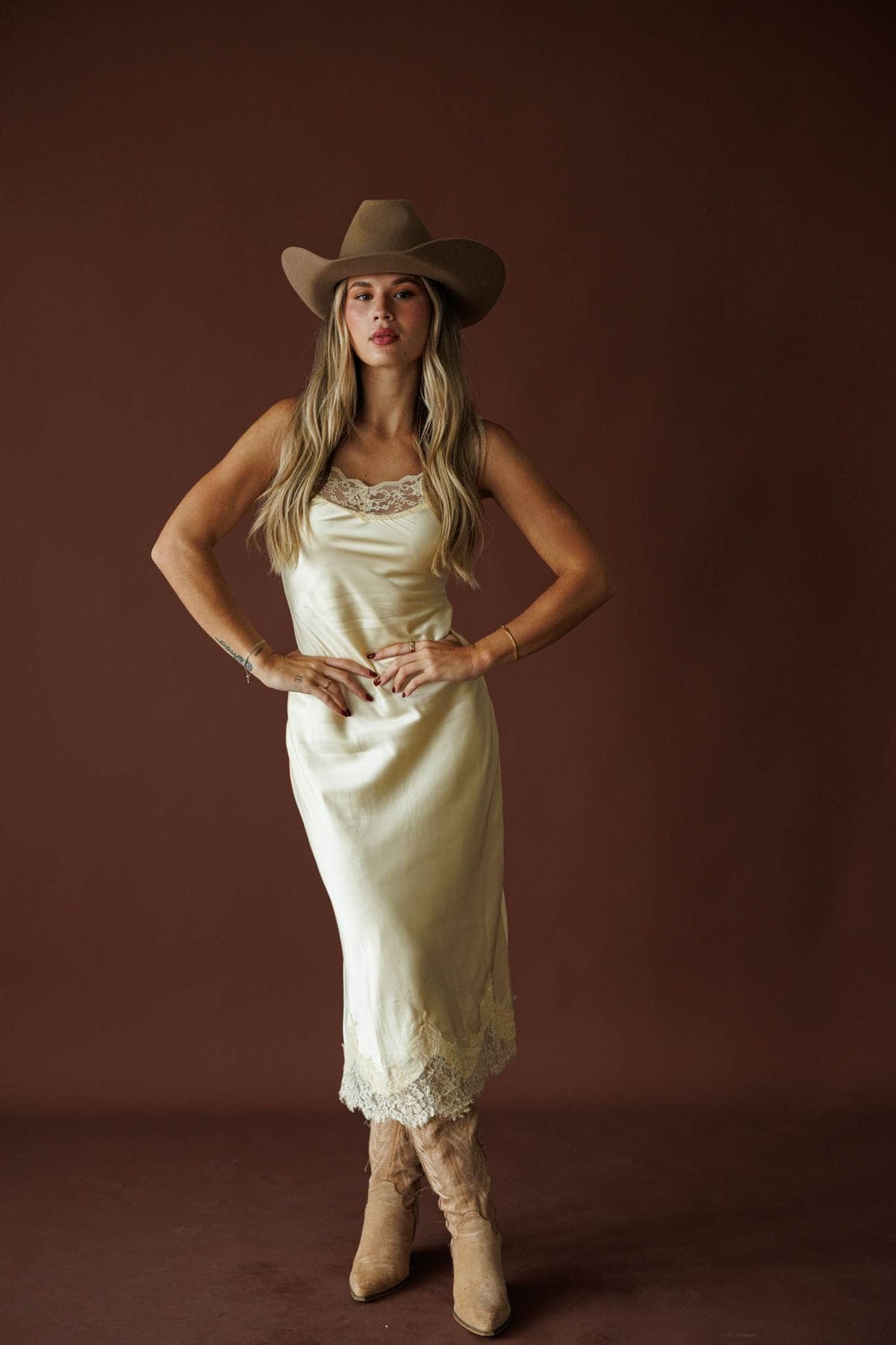 Buttermilk Lace Slip Dress in butter, full-length view on model with hands on hips
