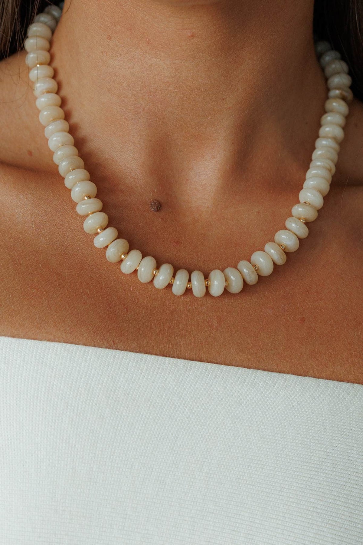 Cream Bead Strand Necklace, worn at the neck over a cream top