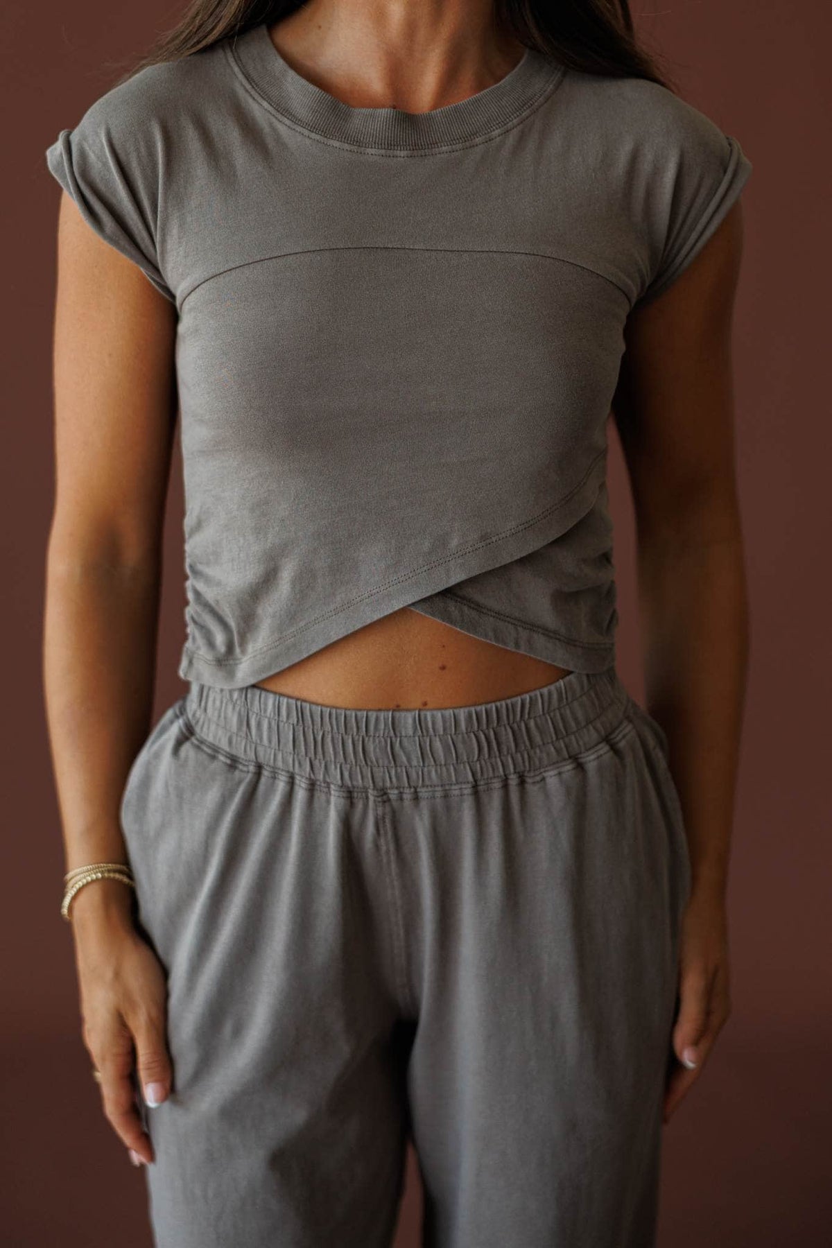 Different Energy Top in truffle, front close-up of the crew neck and crossover hem