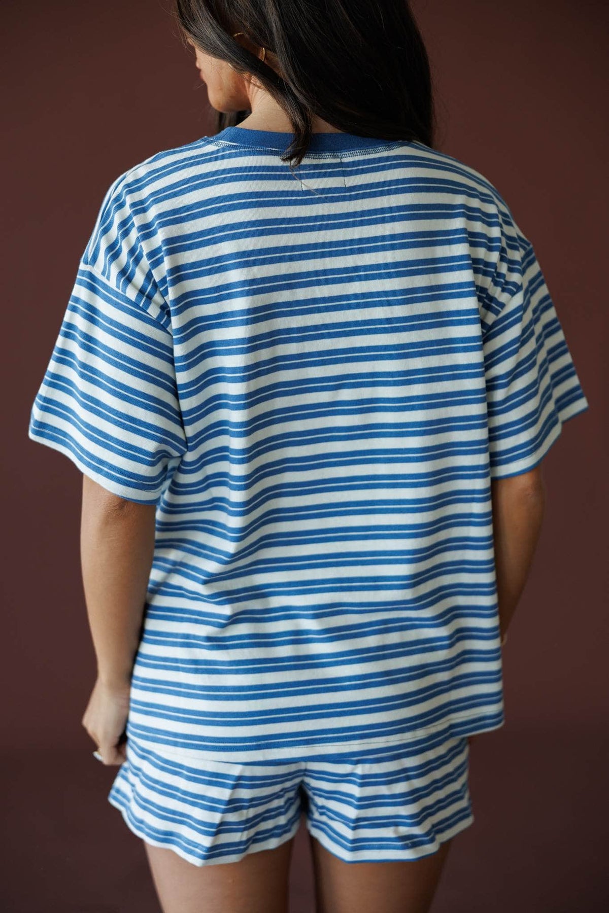 Doing Things Tee in dusty blue, back view close-up showing the striped back and drop shoulders
