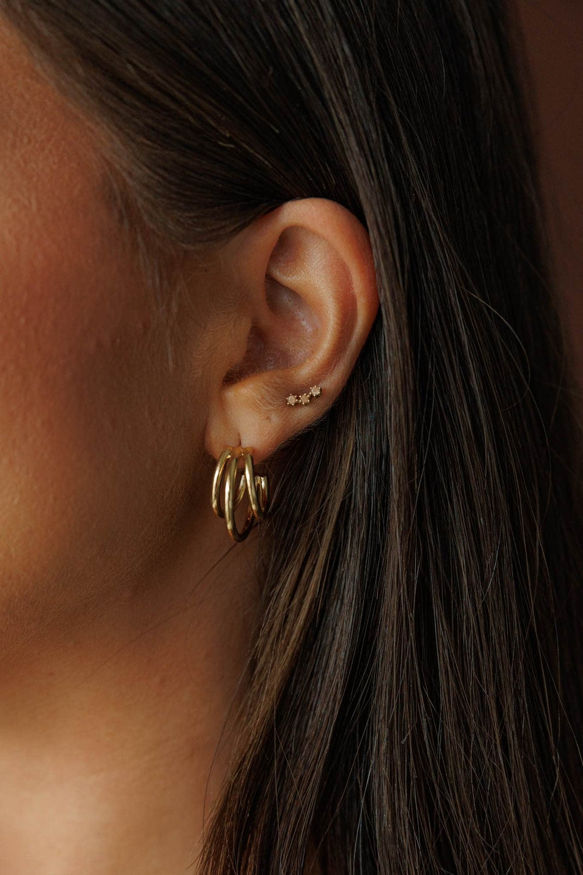 Gold Ribbed Row Hoops, worn on the ear