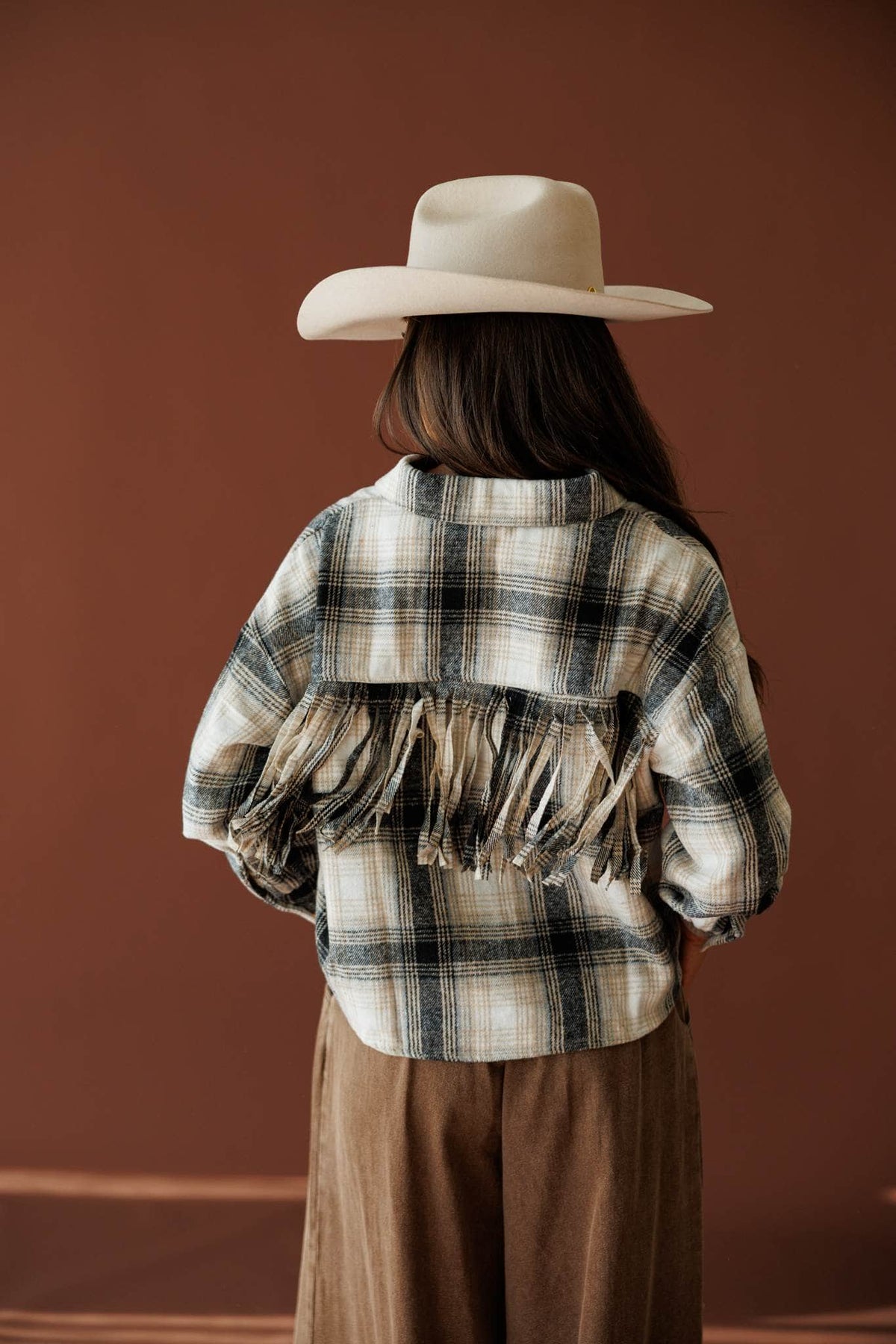 Fringe Lane Plaid Shacket in ivory and black, back view showing the fringe trim yoke