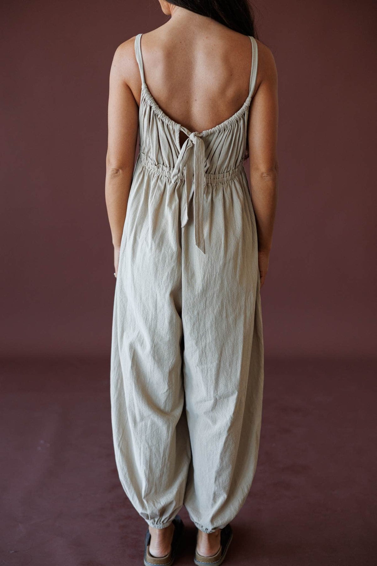 The Roam Jumpsuit, in sand, back view of the tie back