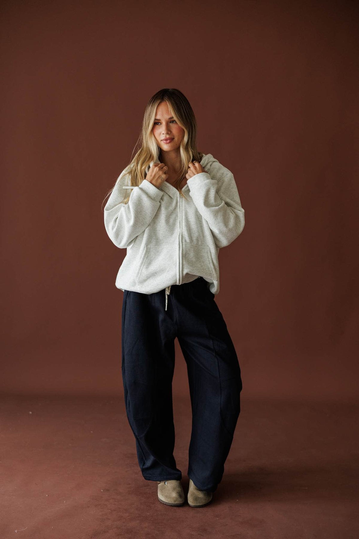 Slow Down Wide Leg Joggers in navy, full-length view with a cream jacket and sneakers