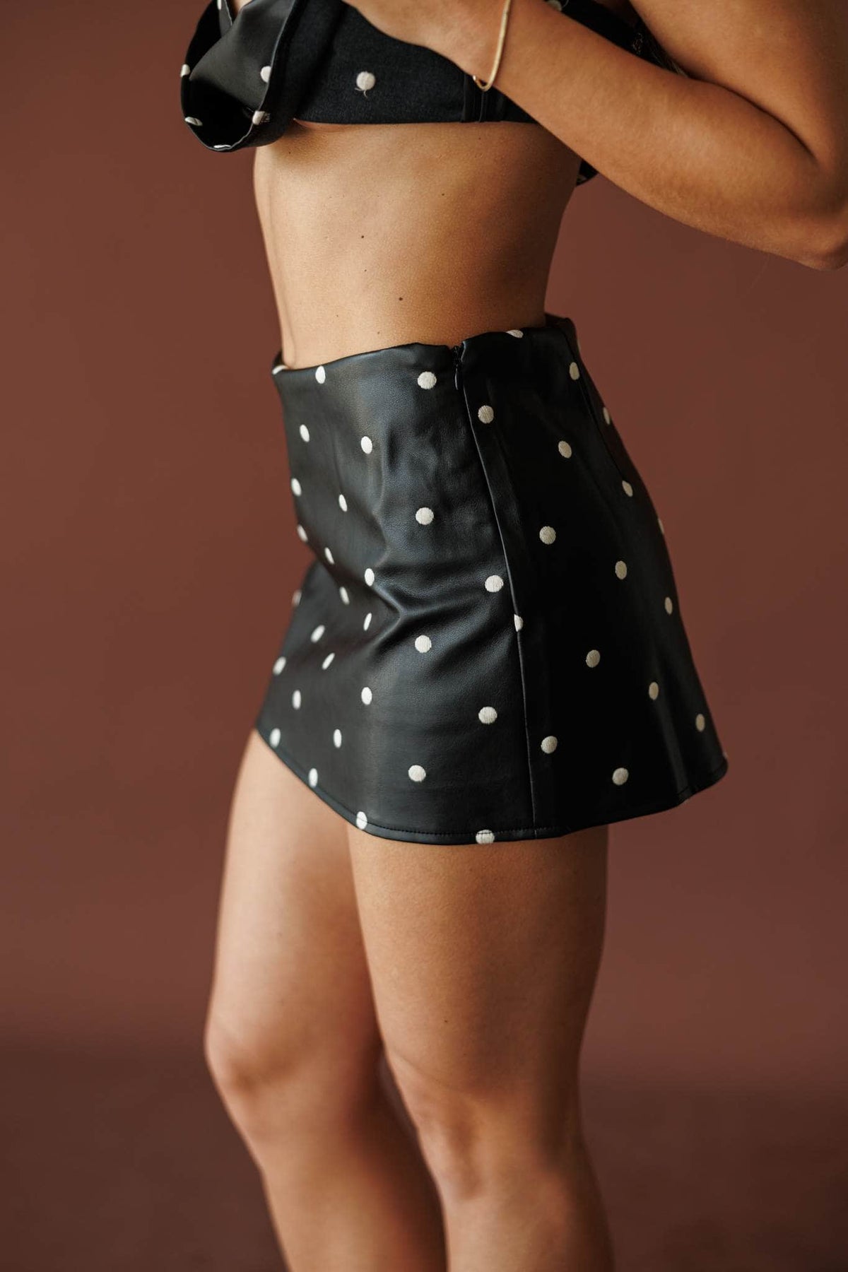 Black faux leather pearl stud mini skirt