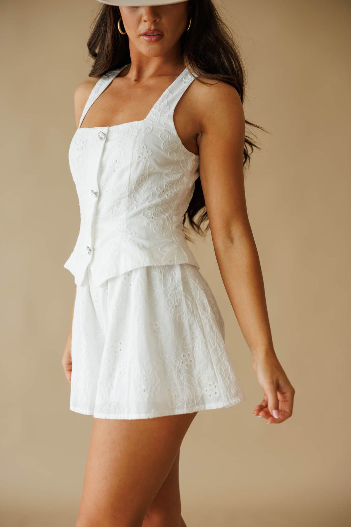 Newly Yours Eyelet Romper in white, side view showing the peplum and eyelet shorts