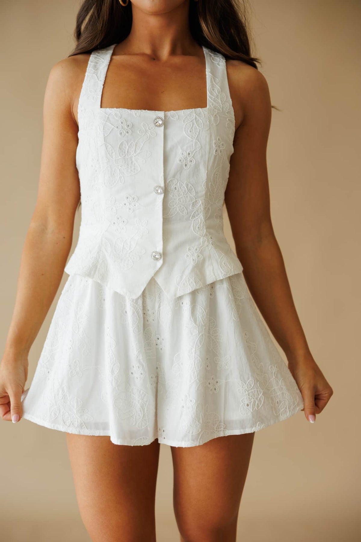 Newly Yours Eyelet Romper in white, front close-up of the button bodice and eyelet fabric