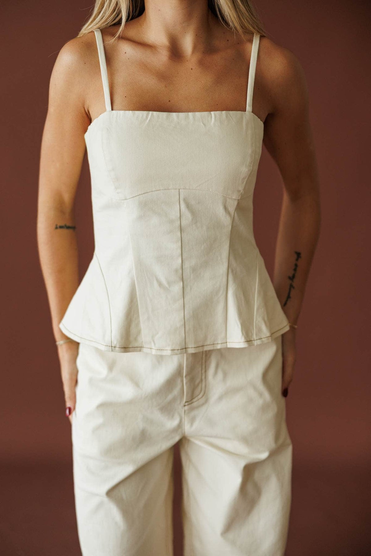 Roadhouse Peplum Top in cream, front view of the adjustable straps and seamed bodice
