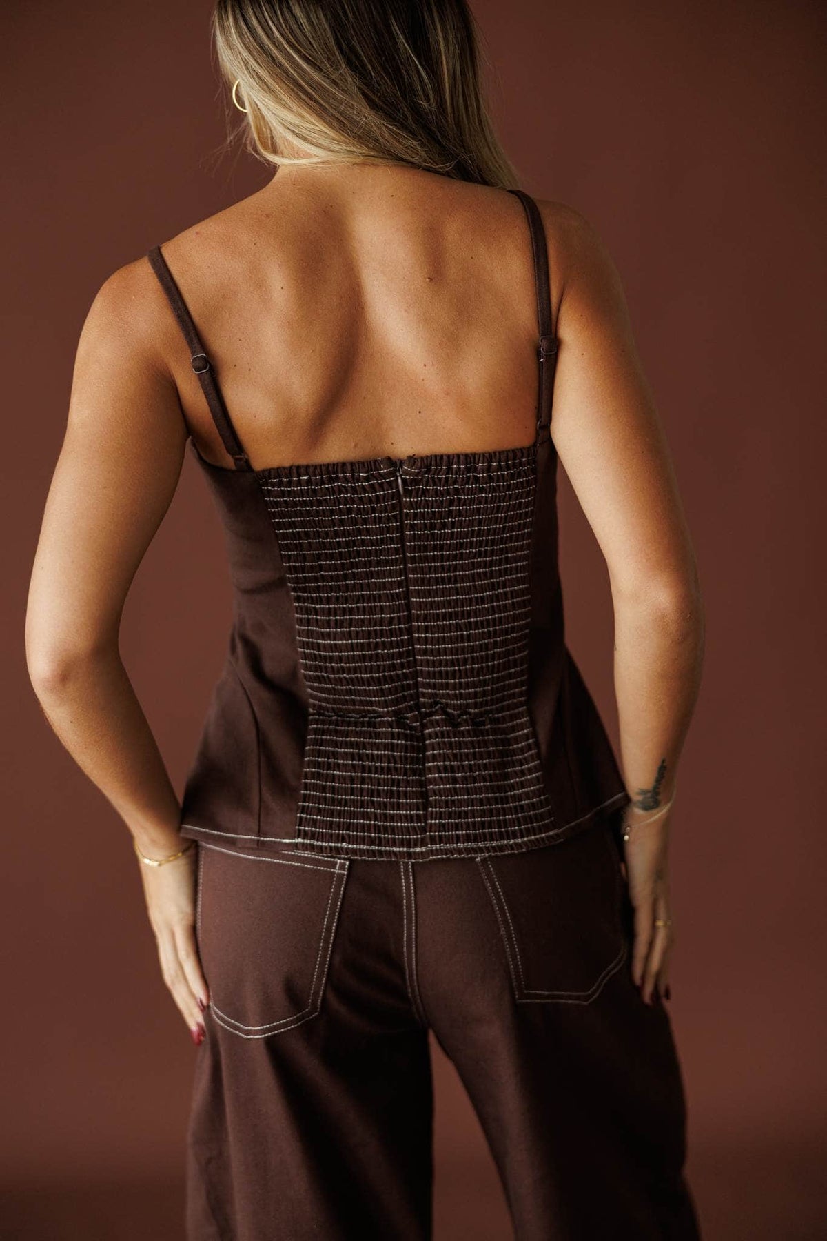 Roadhouse Peplum Top in brown, back view of the smocked back panel