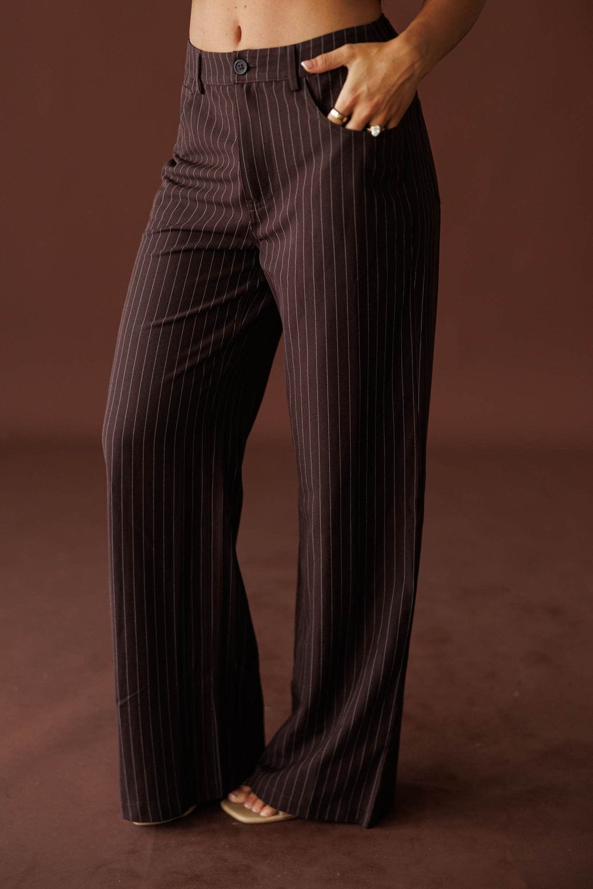 Members Only Pants in brown pinstripe, front view of the high waist and flowing leg
