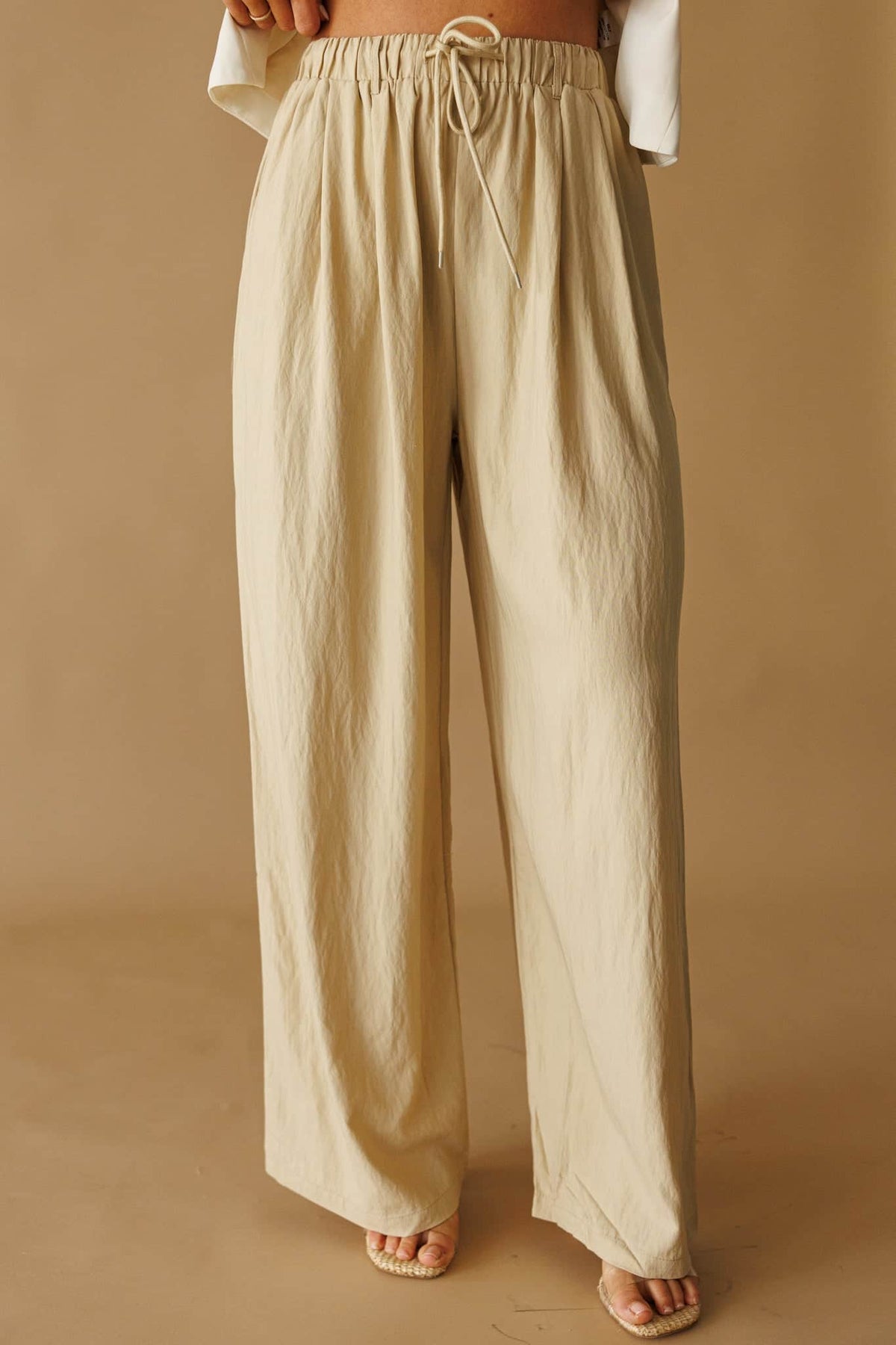 Laguna Linen Pant in natural, front close-up of the drawstring waist and wide leg