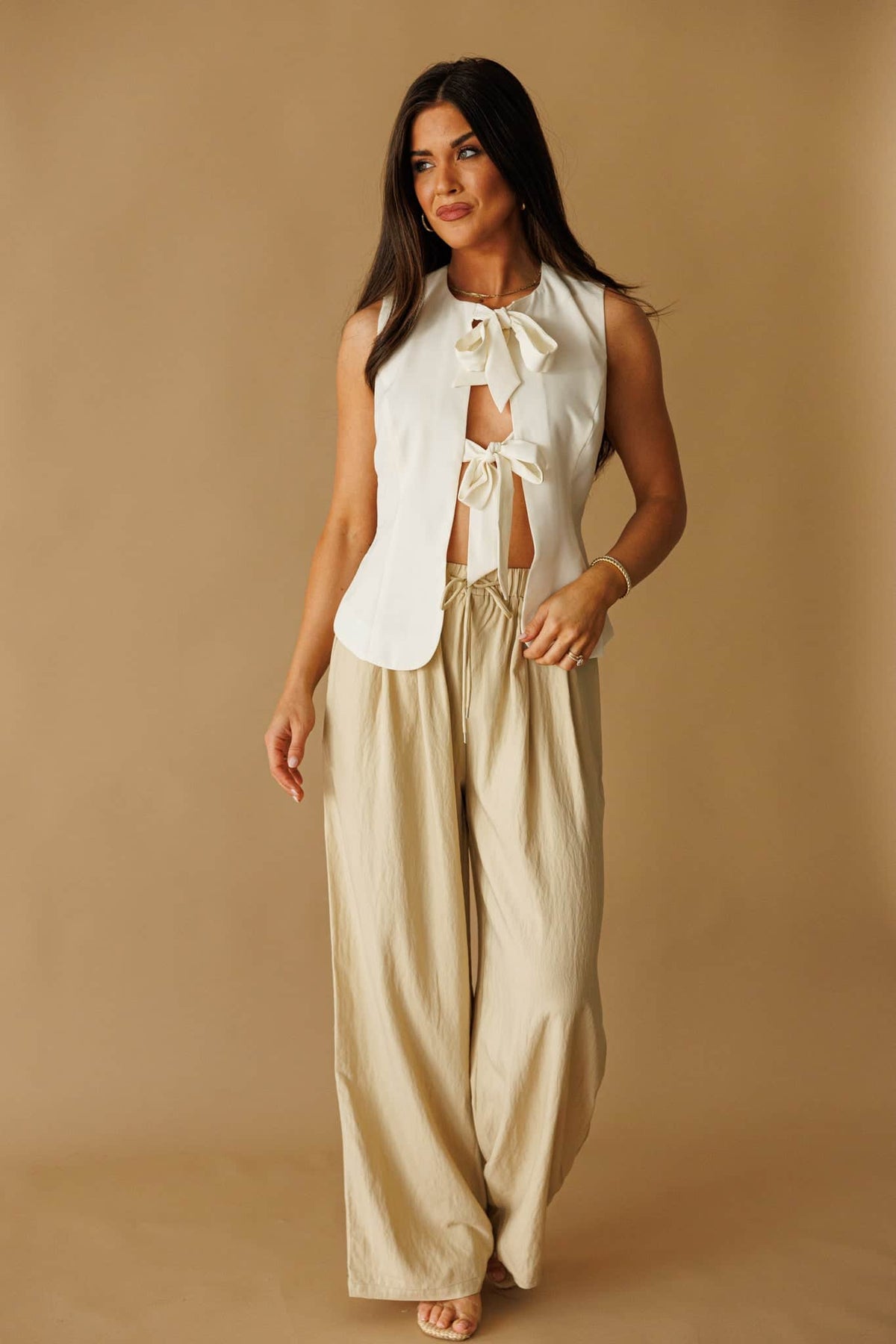 Laguna Linen Pant in natural, front view on model with hand at the waist