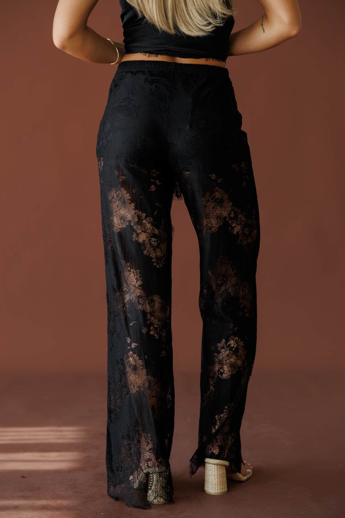 Love Letters Lace Pants in black, back view showing the sheer lace and wide leg