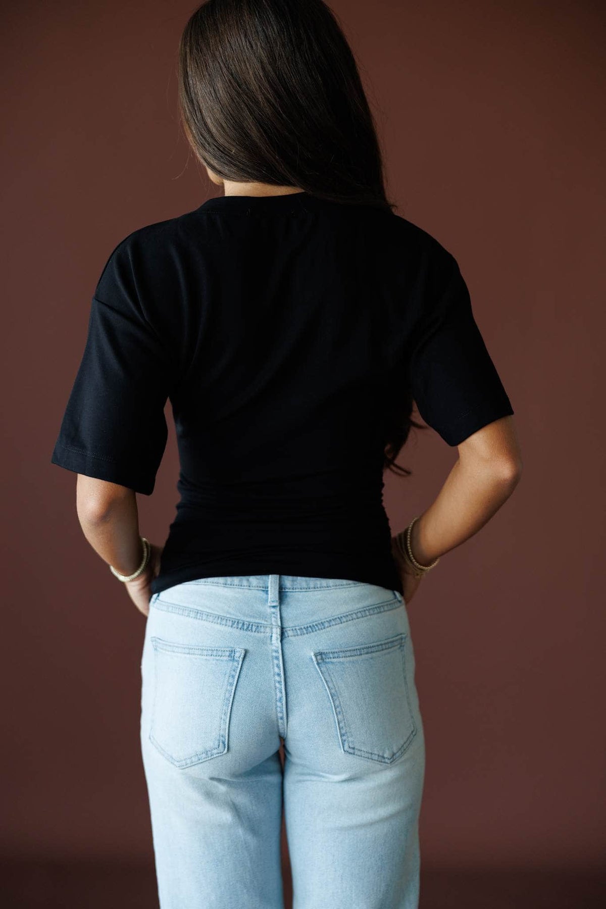 One Sided Ruched Tee in black, back view on model showing the plain smooth back
