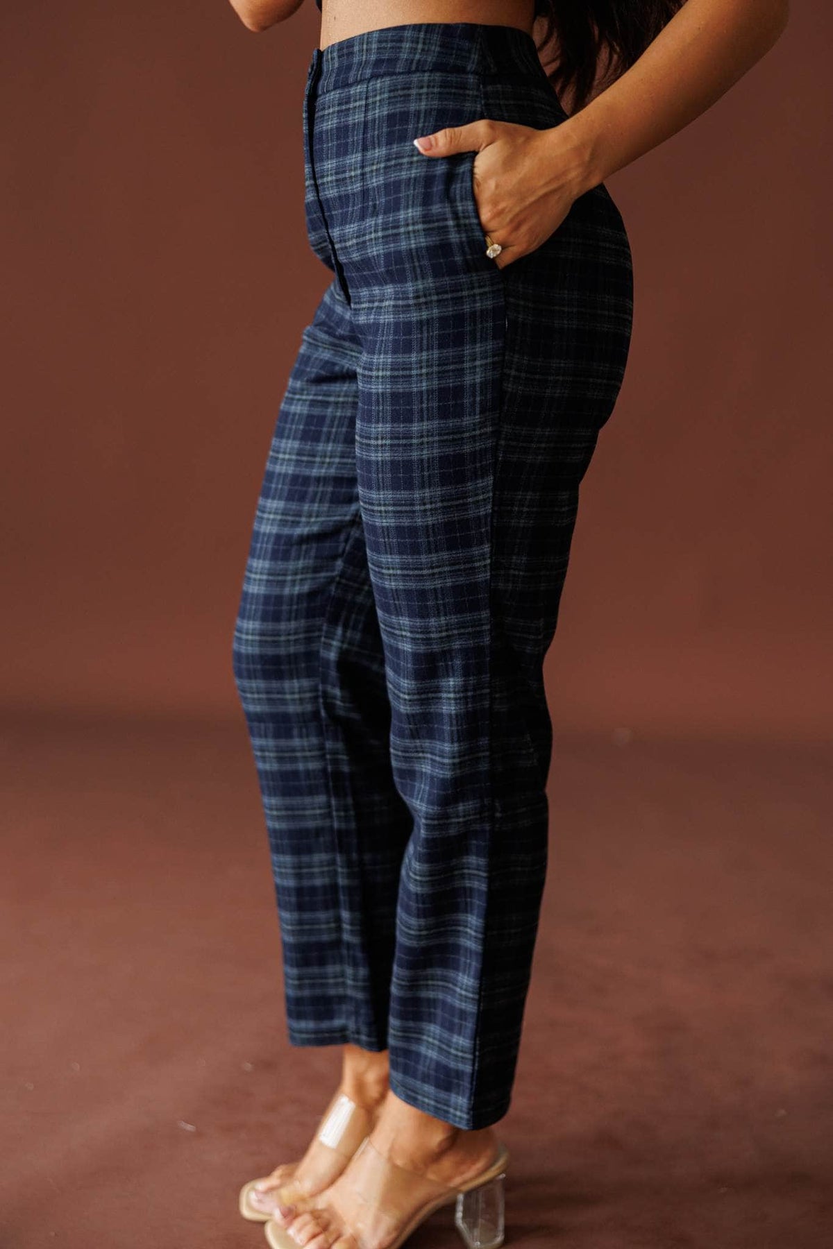 The Socialite Pants in teal plaid, side view with hand in the pocket