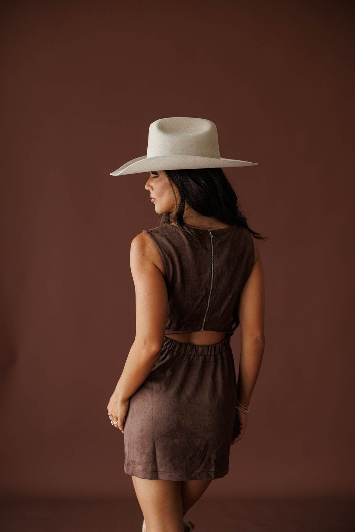 Saddle Up Suede Mini Dress in chocolate, back view on model with a cream hat