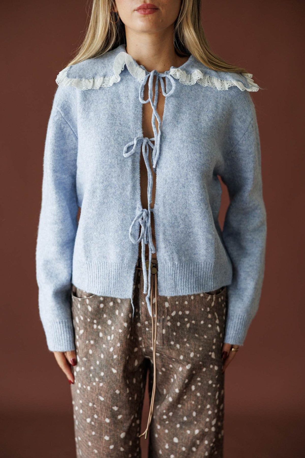 Sweet Collar Knit Cardigan in blue, front close-up of the cream ruffle collar and ties