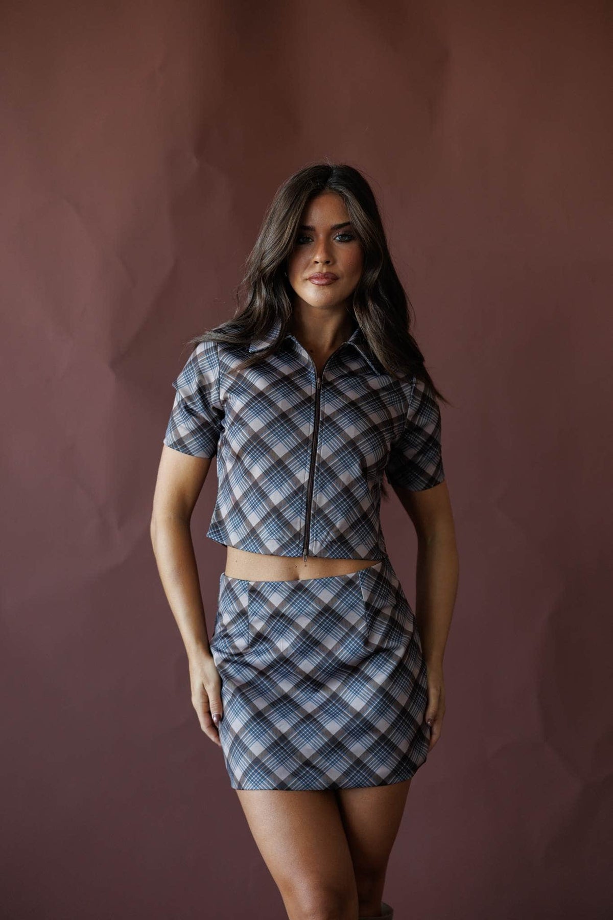 Grey and blue plaid zip front top, front view