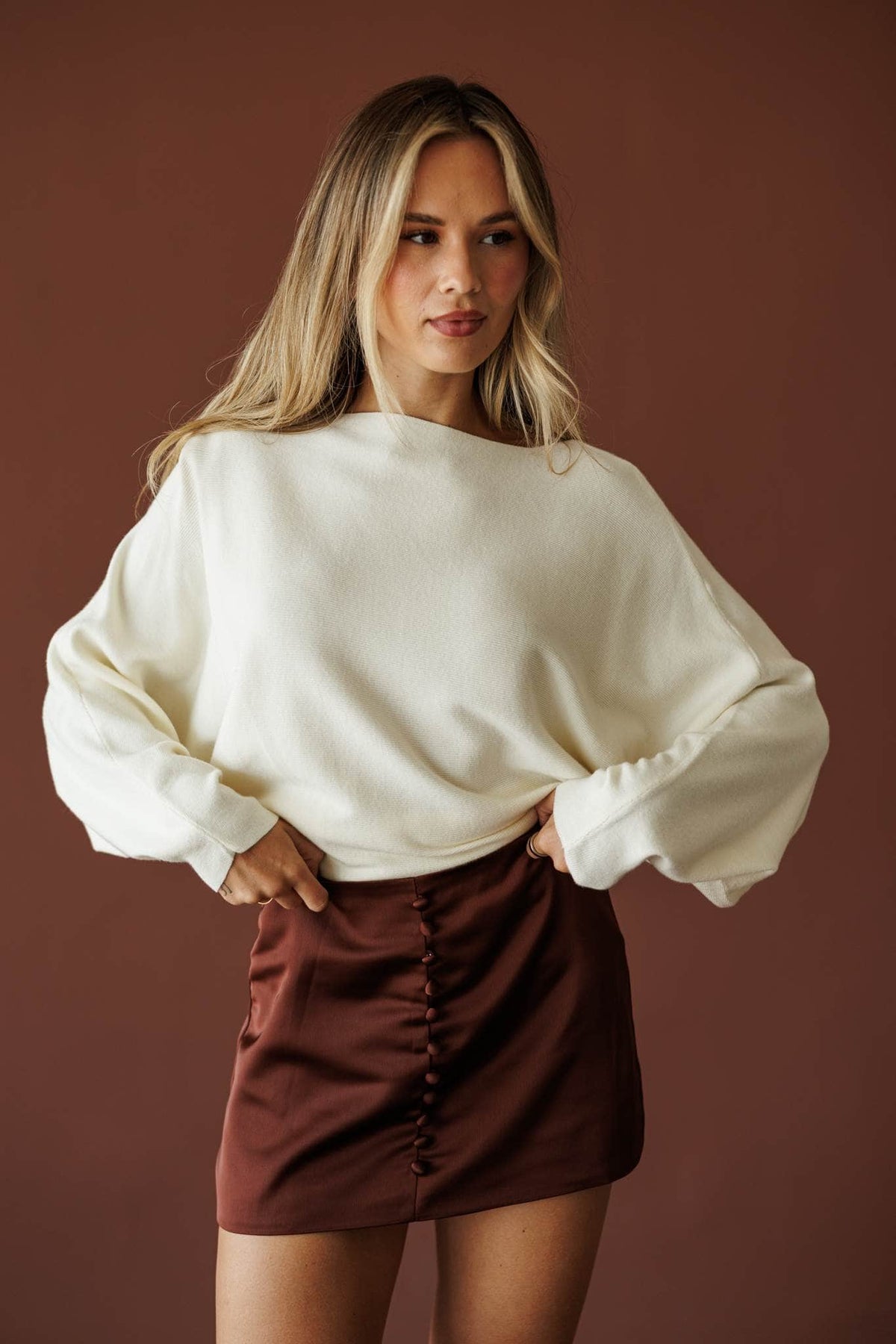 Cream boat neck knit top with blouson sleeves, front view