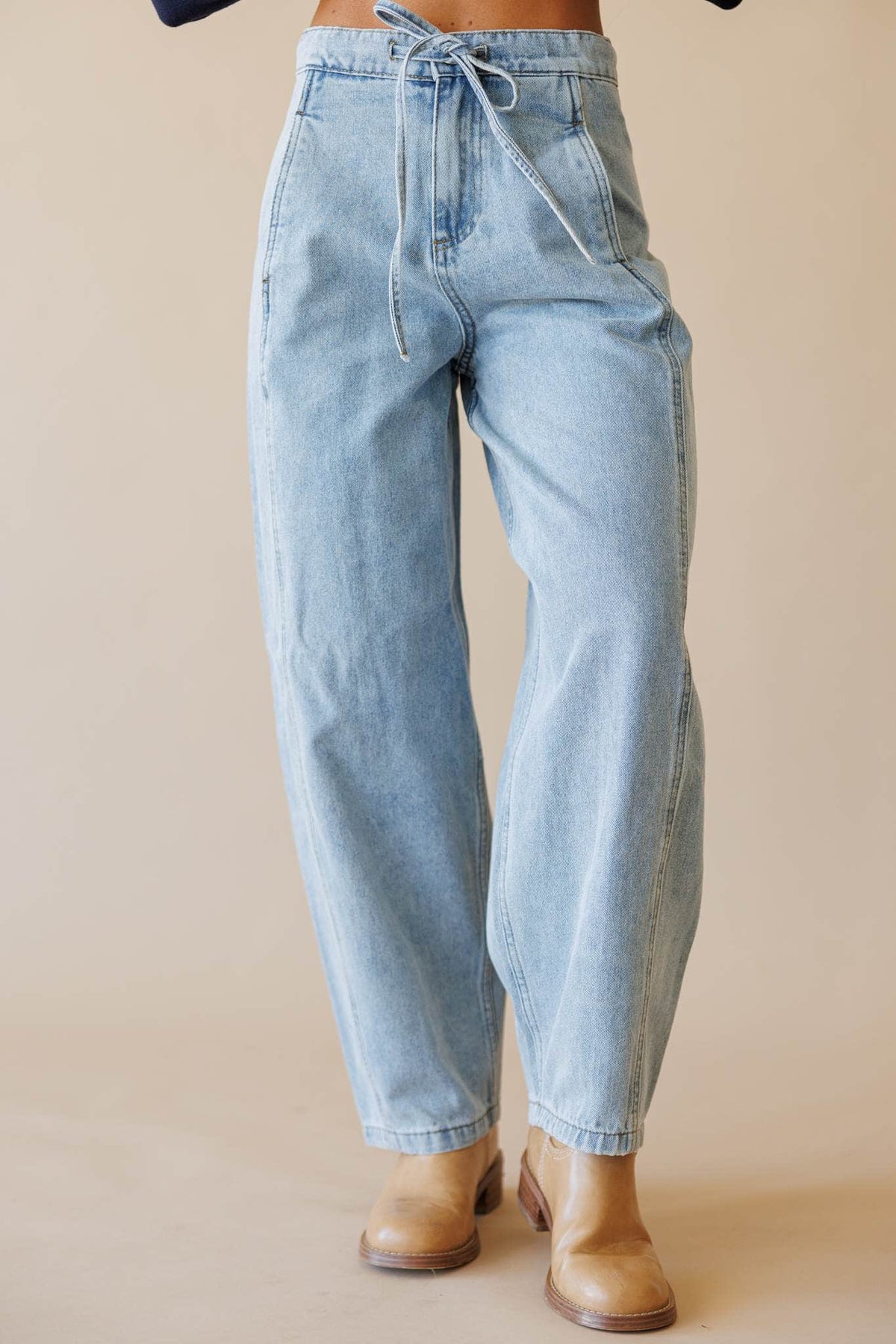 Light wash denim barrel leg pants, front view