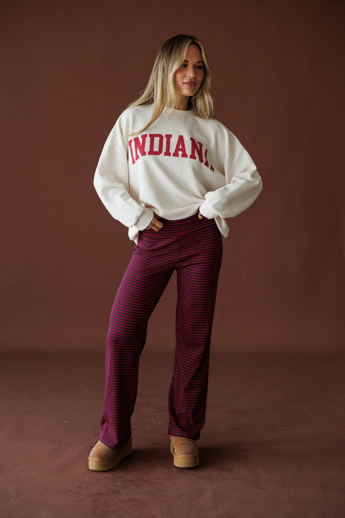 Everyday Stripe Yoga Pants in navy and burgundy, full-length view with a cream Indiana sweatshirt