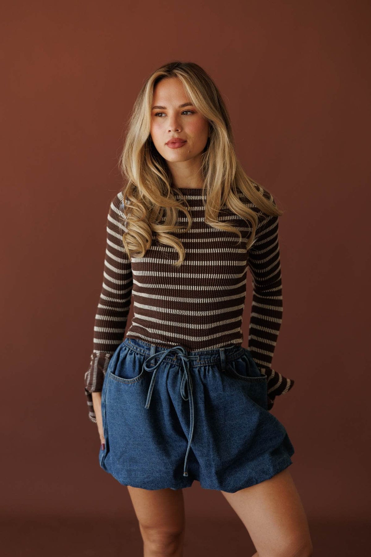 Coffee Stripe Long Sleeve Top, front view with a denim skirt