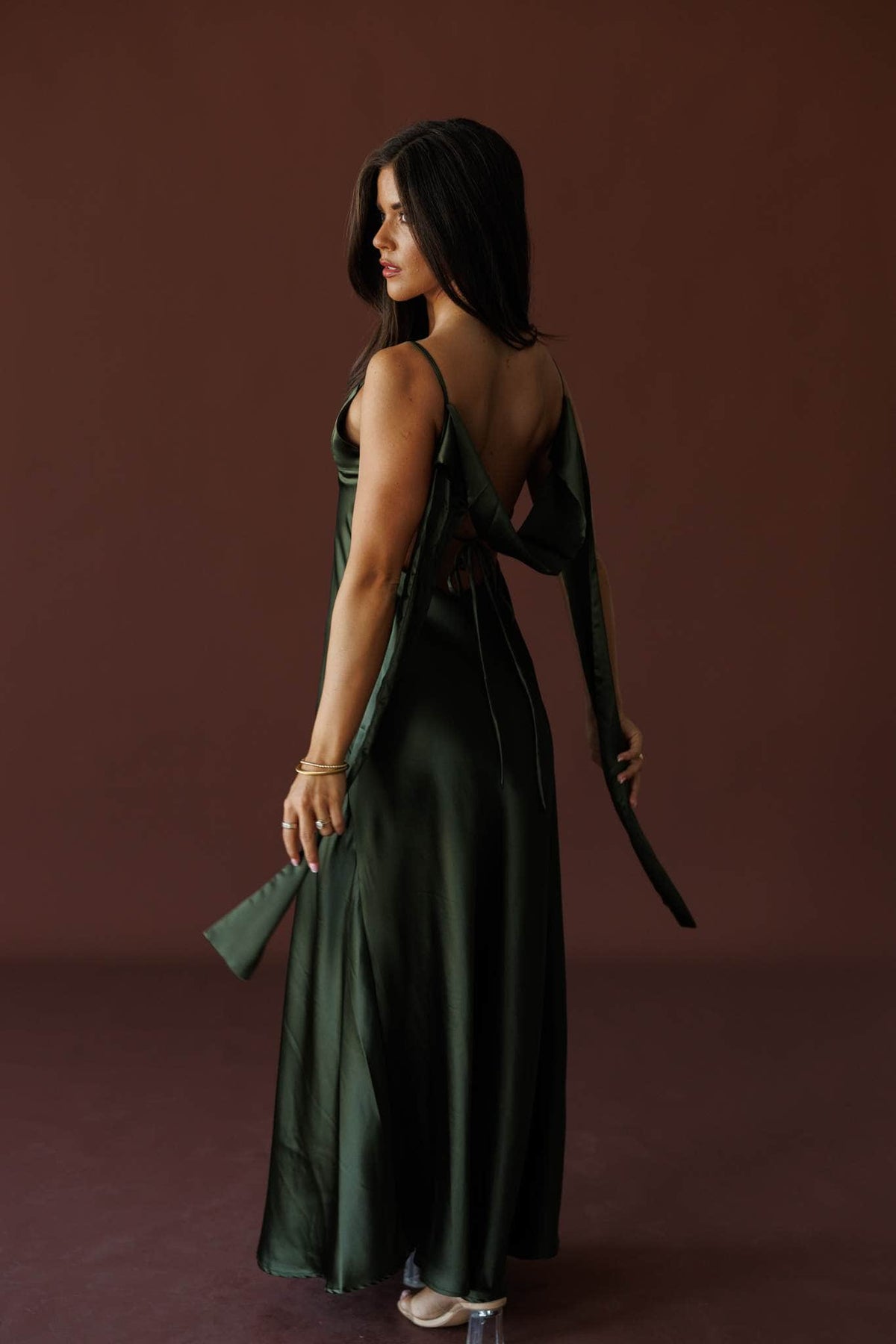 The Candlelight Dress in khaki, back view on model holding the tie