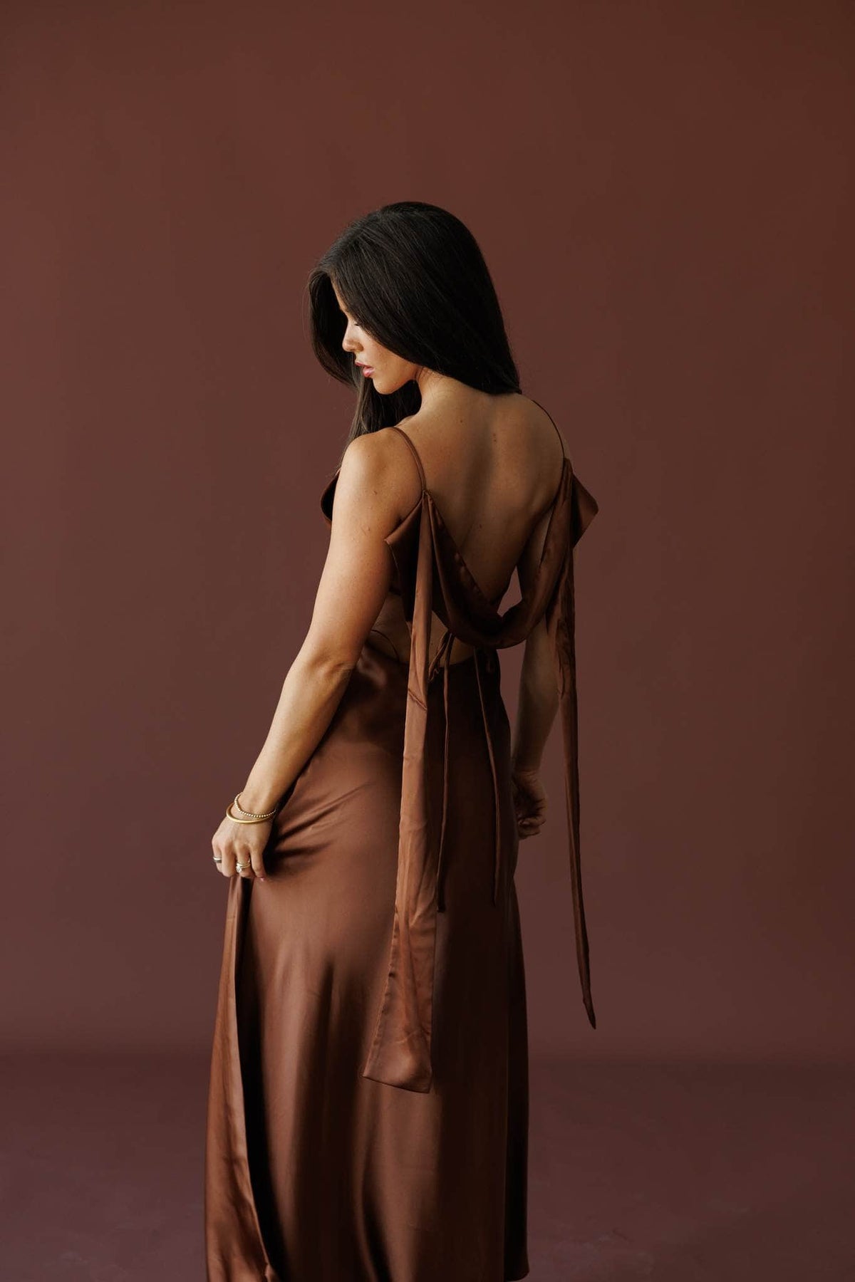 The Candlelight Dress in brown, back view showing the tie back and satin gown