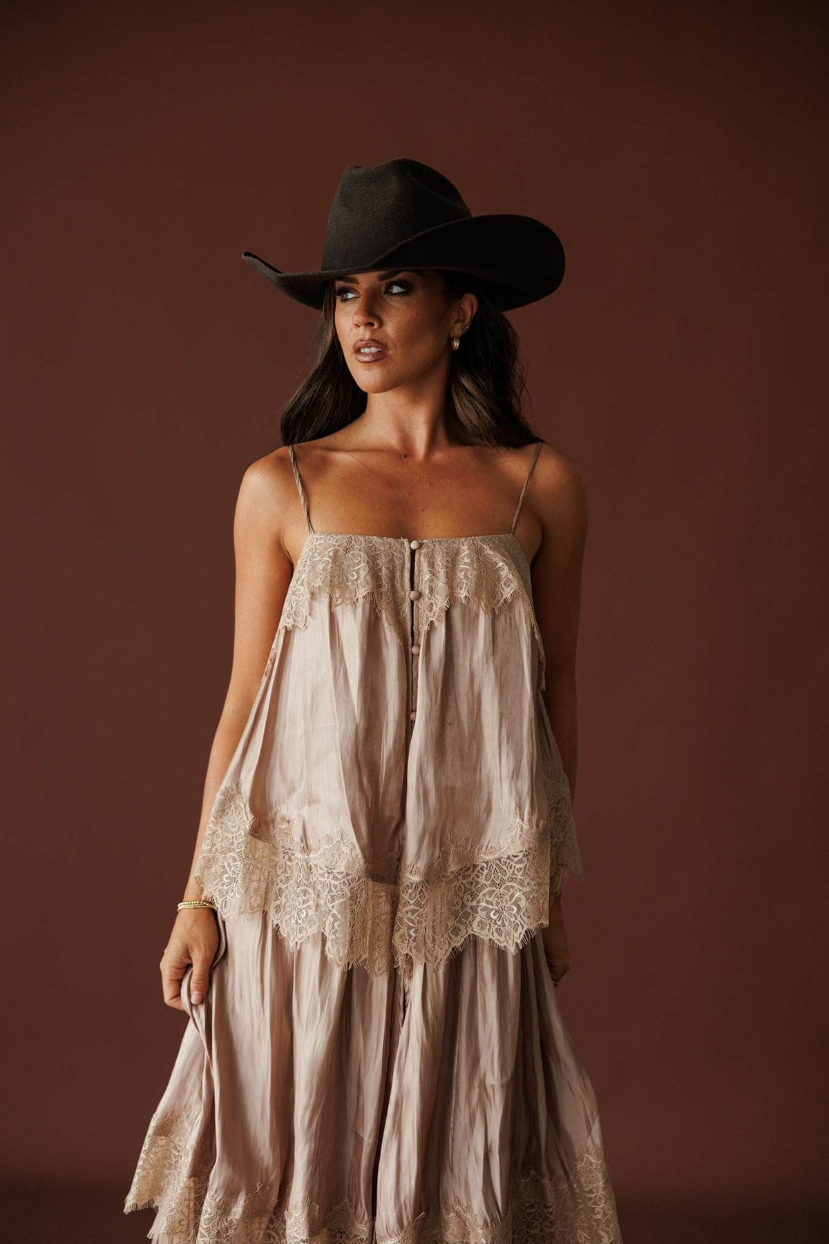 Where The Wildflowers Grow Maxi Dress in sand, front view of the smocked bodice with a black cowboy hat