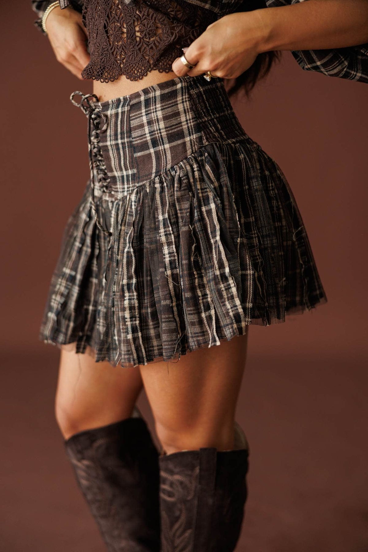 Harvest Social Plaid Skort in chocolate, side view of the lace-up waist detail