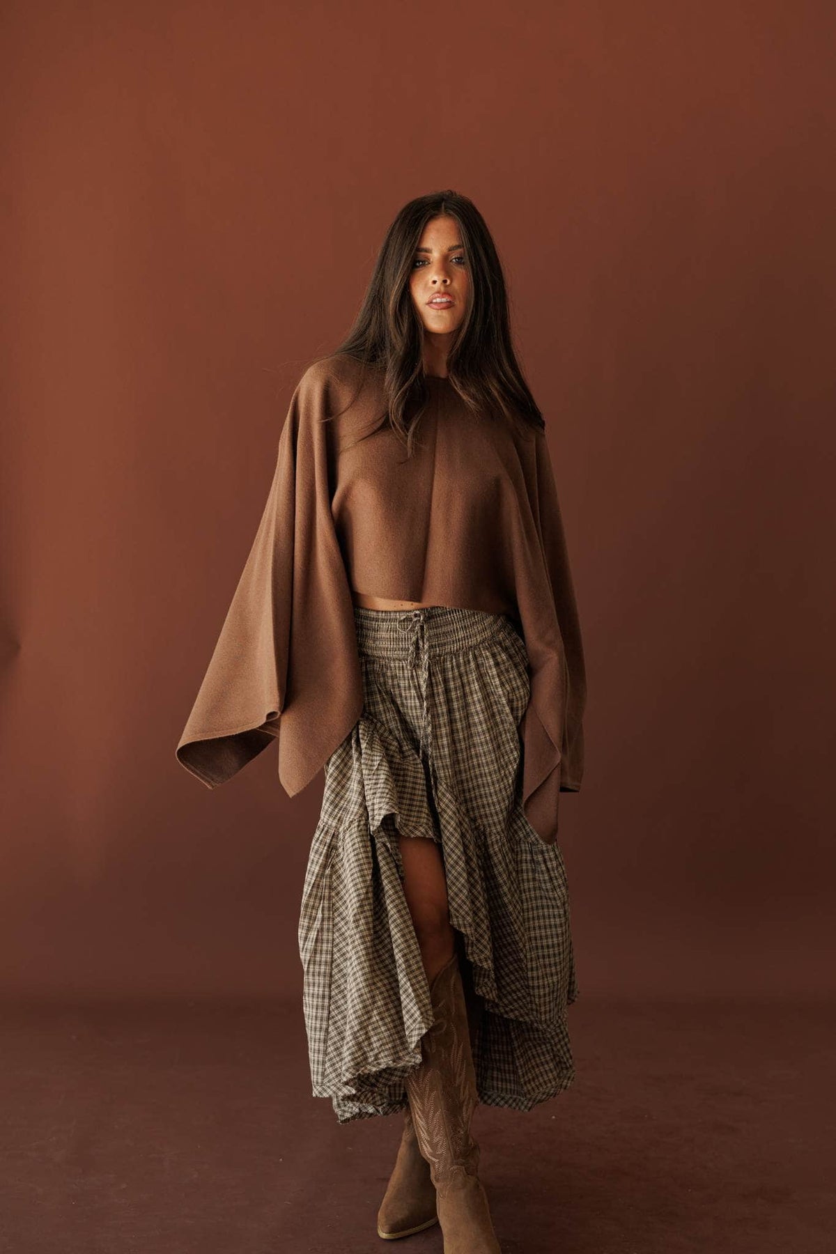 Wide Open Boat Neck Sweater, in brown, three-quarter view with a checked skirt