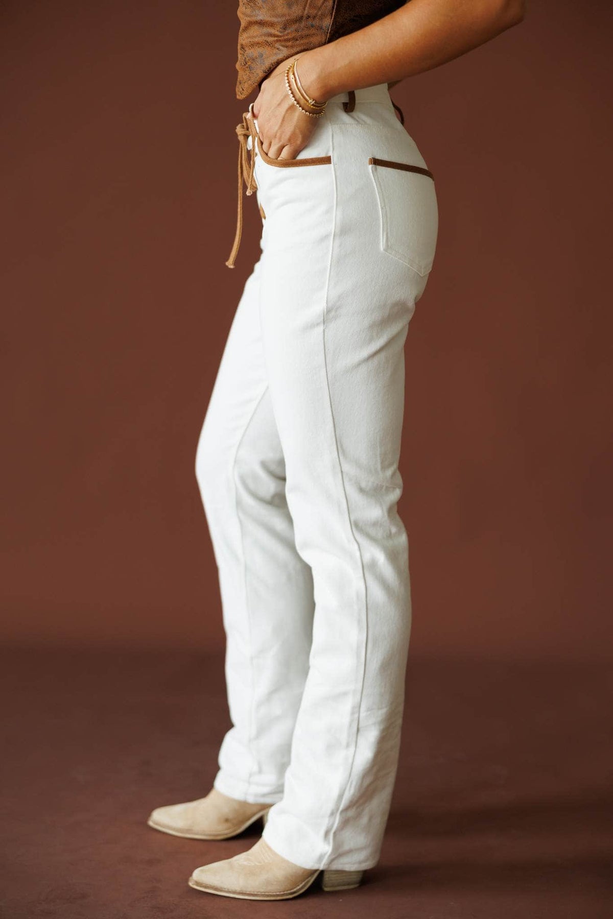West Coast Wild Jeans in ivory, side view showing the straight leg and cream boots