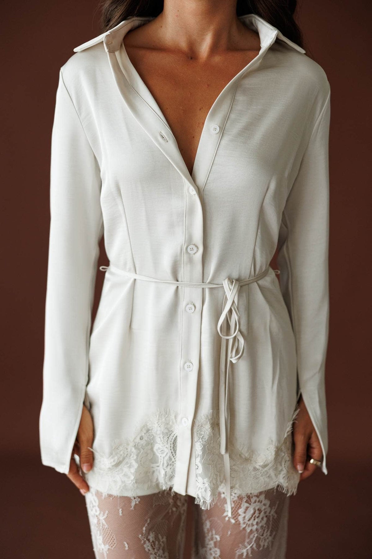 Lace Getaway Top in champagne, front view on model with a hand at the waist