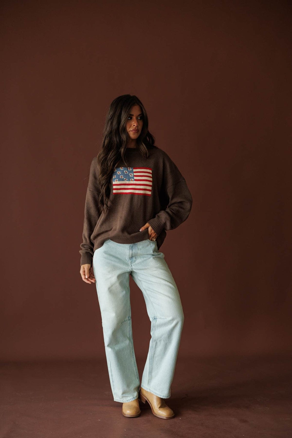 Homegrown Flag Sweater in cocoa, full-length view on model with cream wide leg jeans