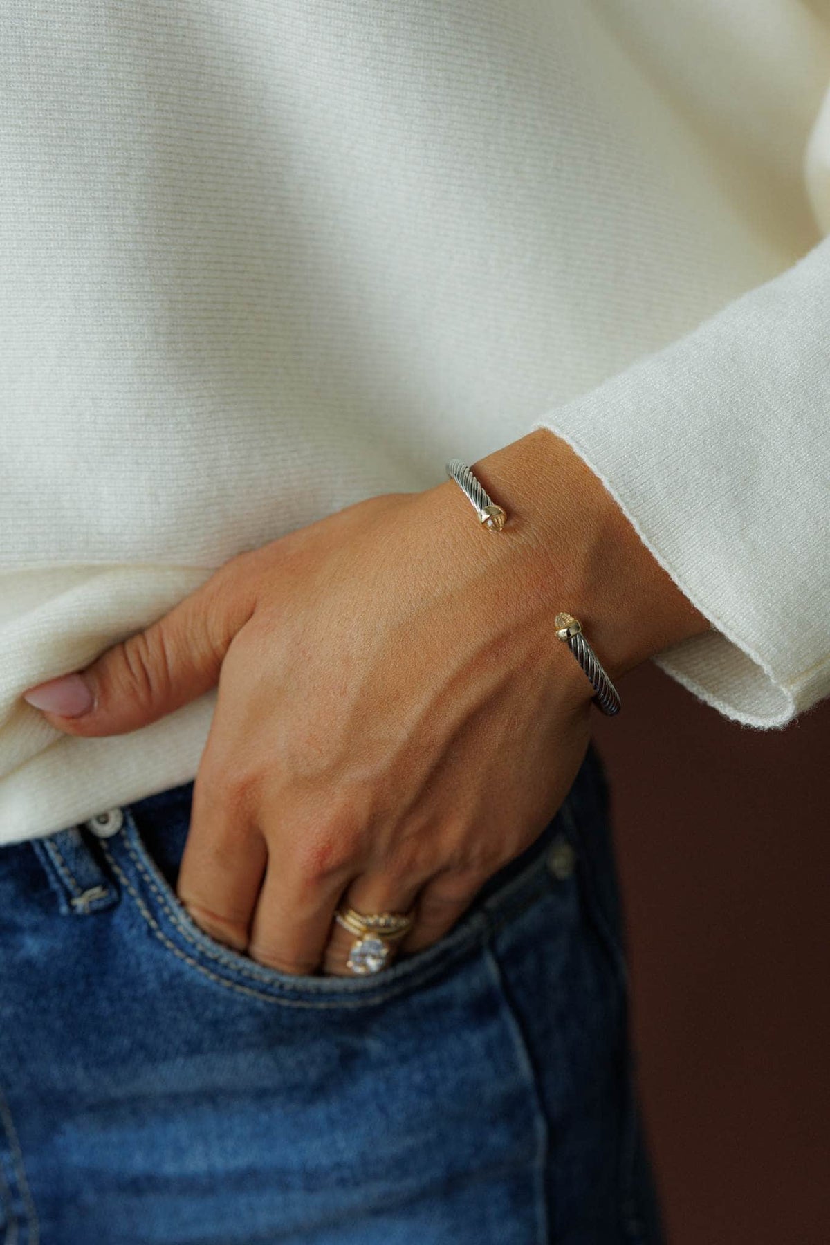 Pearl Tip Cuff Bracelet, worn on the wrist with a cream knit sleeve