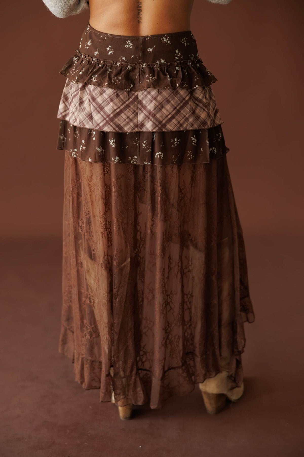 The Storyteller Skirt in brown, front view showing the smooth waist and sheer tiers