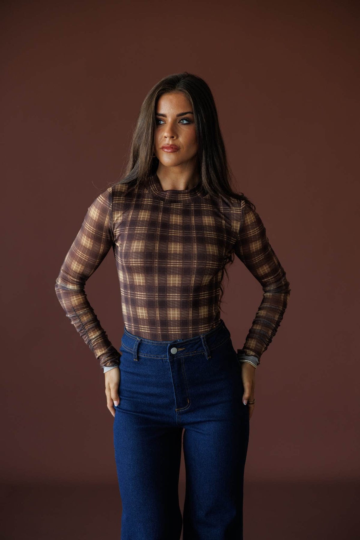 Bookmarked Plaid Mesh Bodysuit in brown and butter, full-length view with dark wash jeans