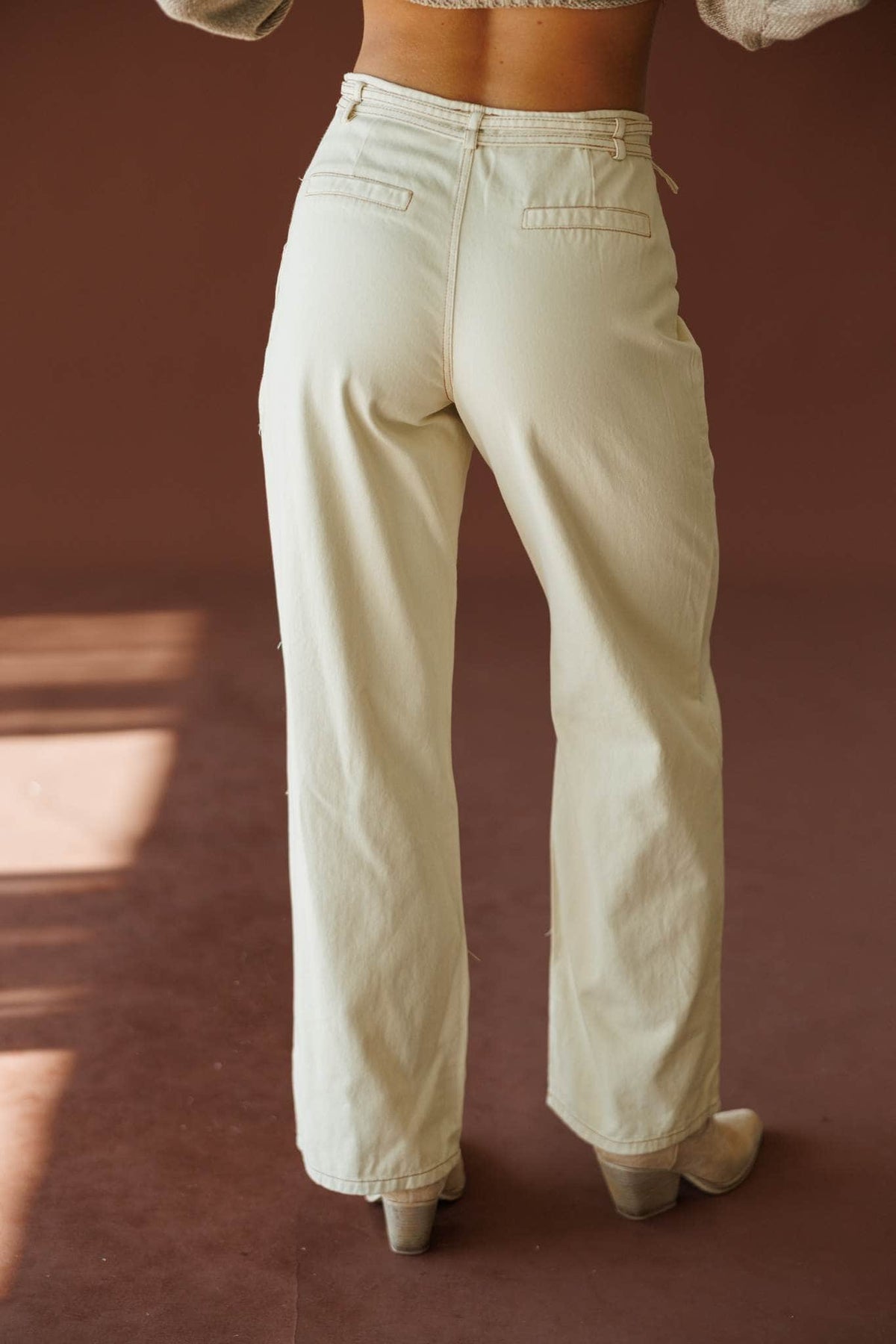 Buckle Point Pants in taupe, back view showing the patch pockets and wide leg