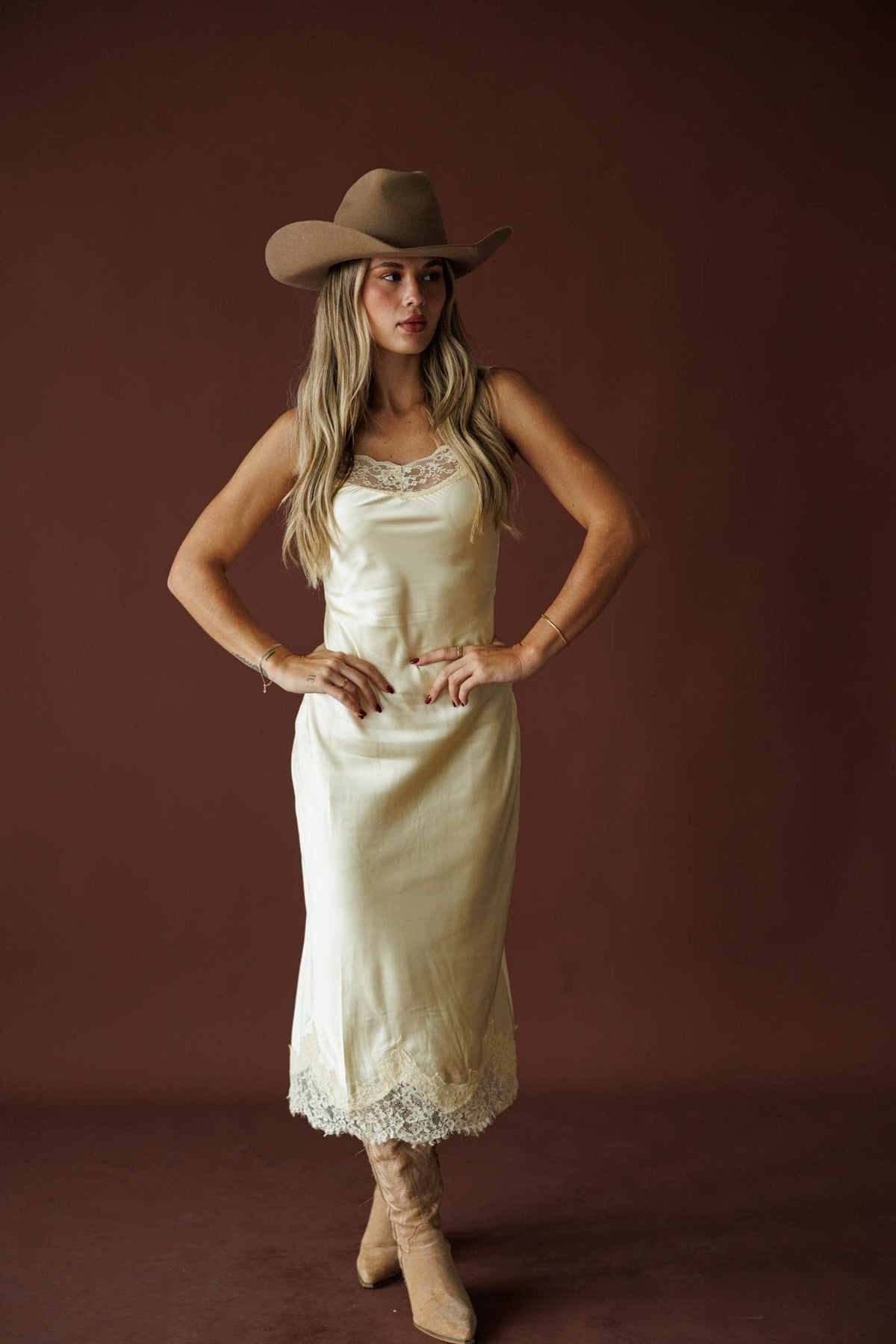 Buttermilk Lace Slip Dress in butter, full-length view with a tan hat and boots
