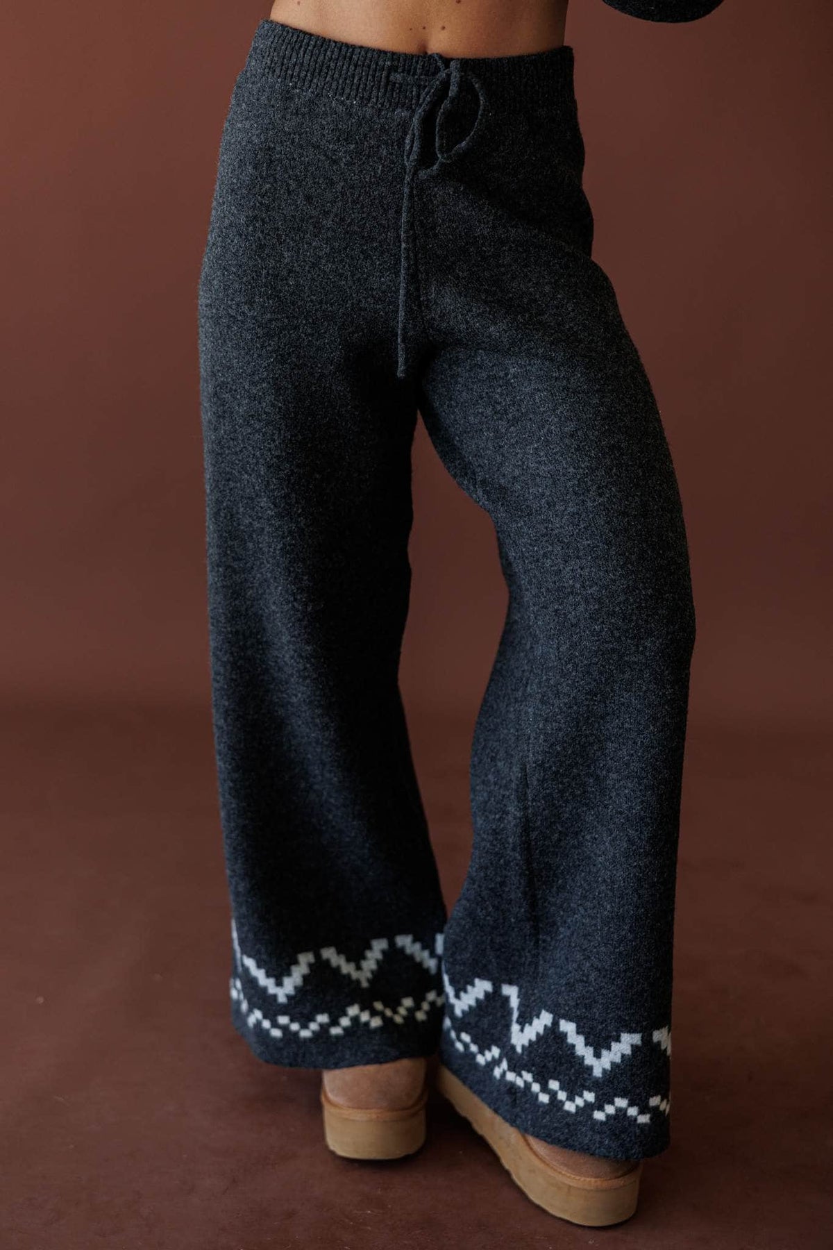 Cabin Cozy Sweater Pants, in charcoal, front view of the wide leg and patterned hem