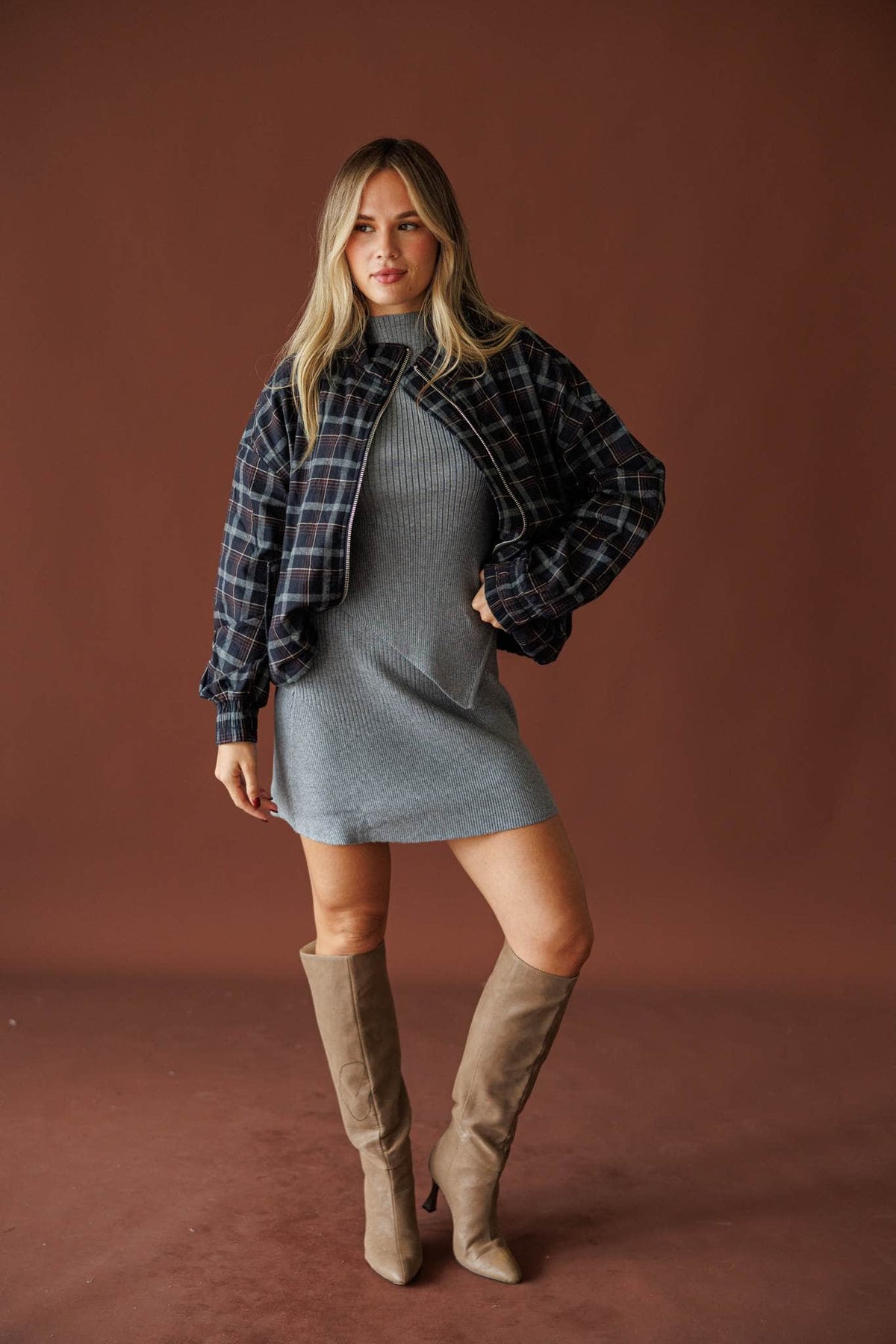 Homecoming Plaid Bomber Jacket in navy multi, full-length view with a grey dress and tall boots
