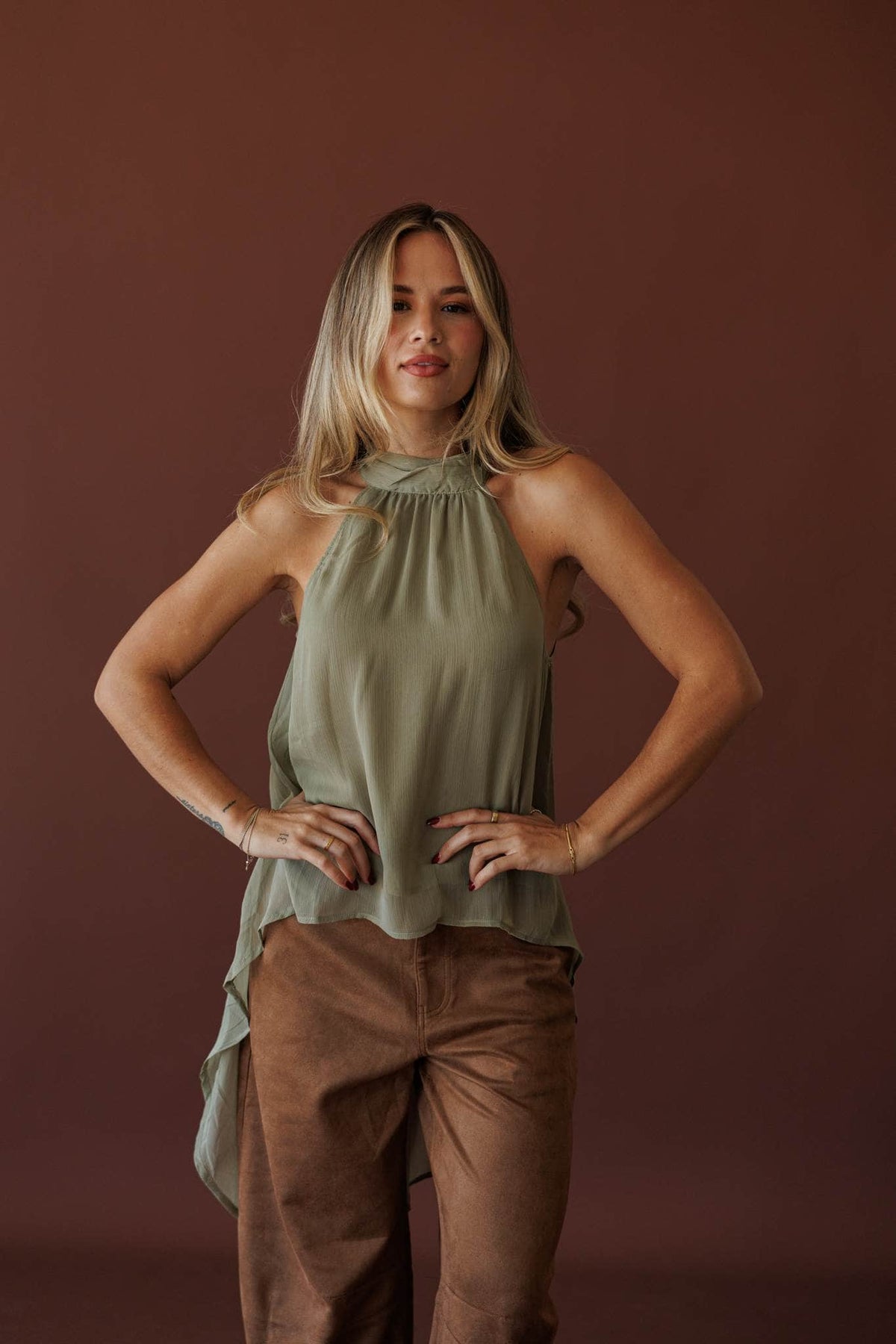 Olive Branch Halter Top, full-length view with brown trousers