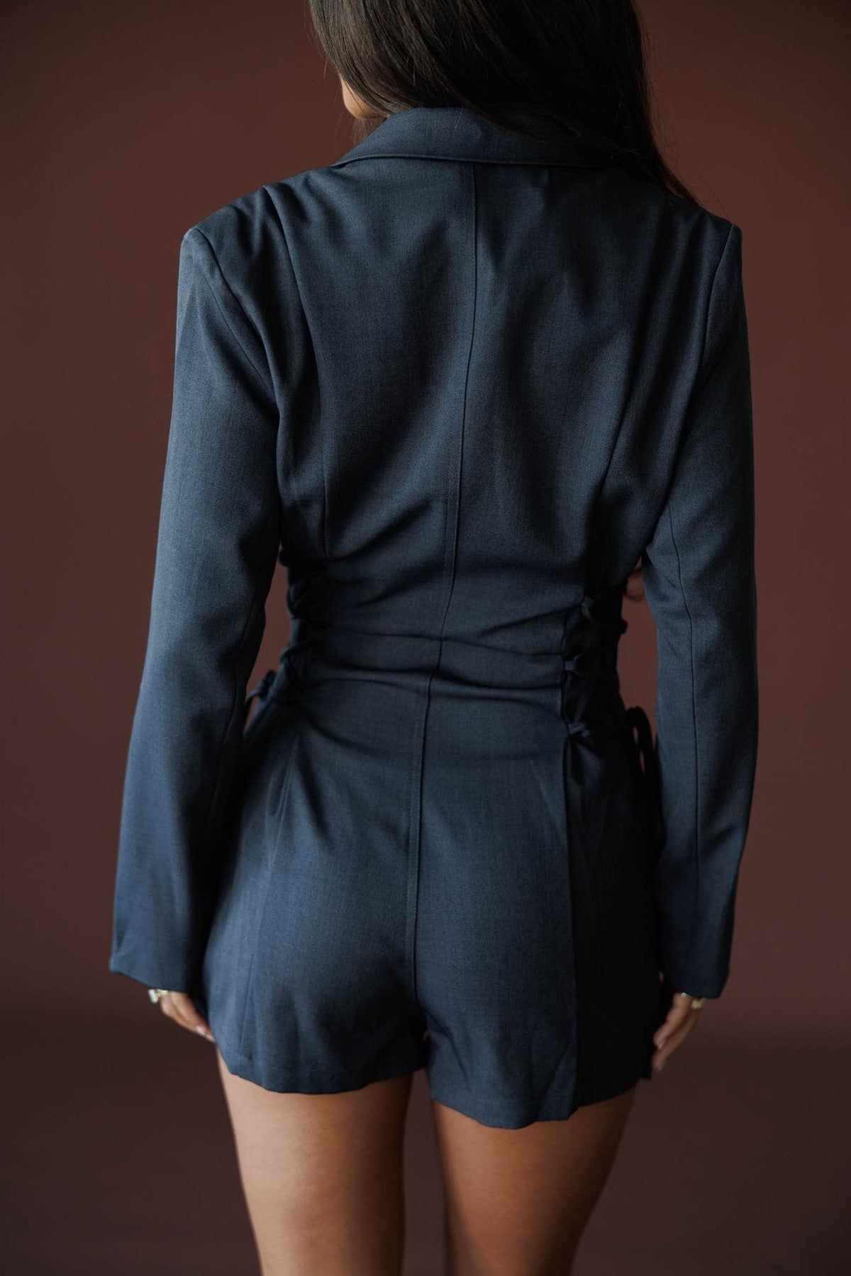 Closing Argument Romper in charcoal, back view showing the blazer romper and shorts