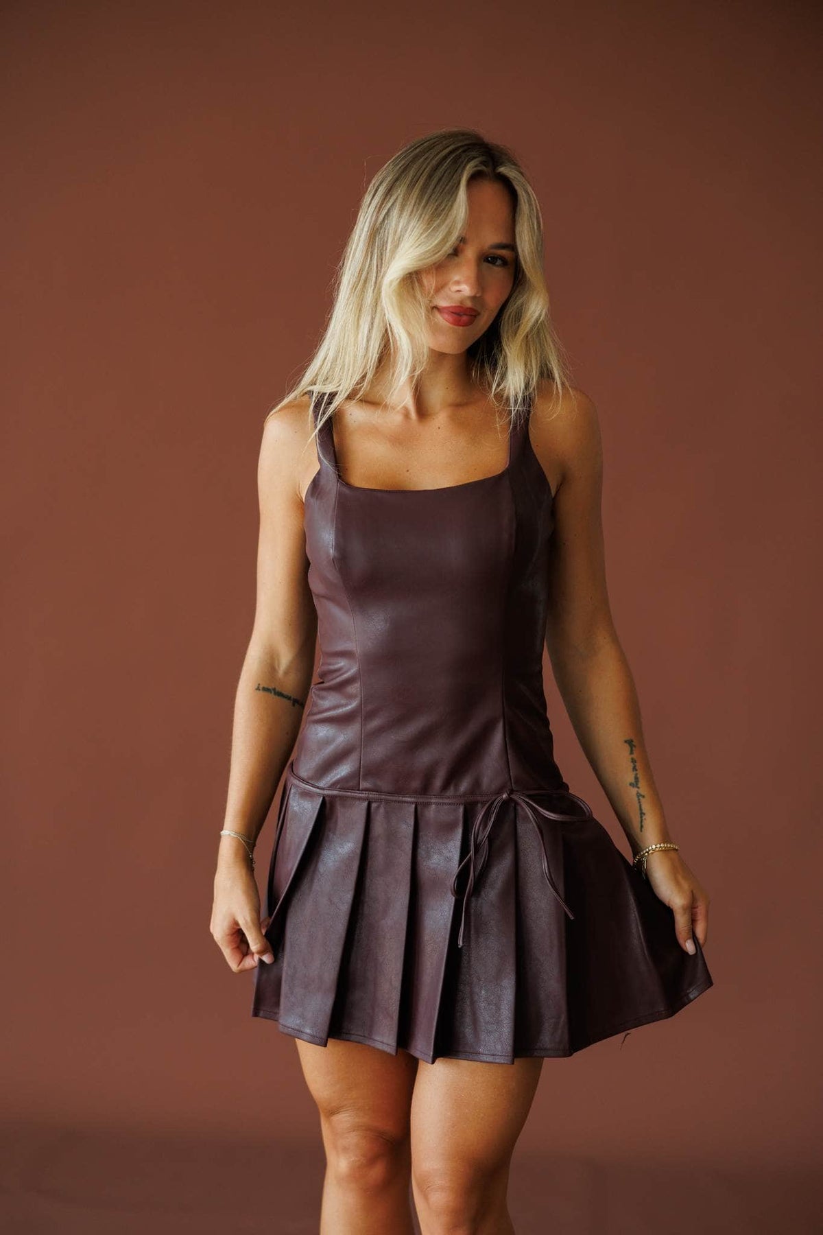 Cover Girl Leather Dress in dark plum, full-length view on model with hands at sides
