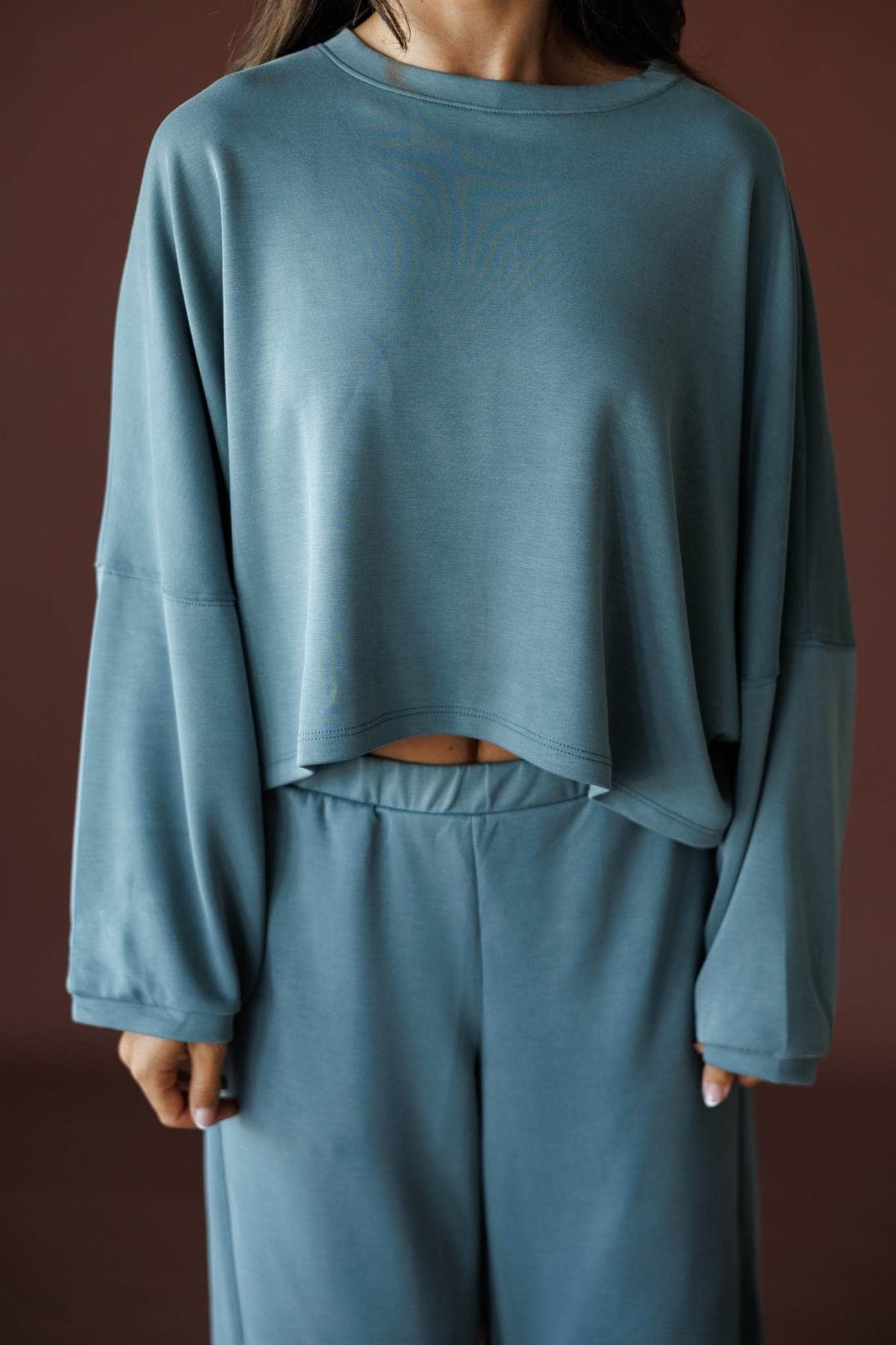 Cropped Scuba Dolman Top in charcoal, front close-up of the crew neck and cropped hem