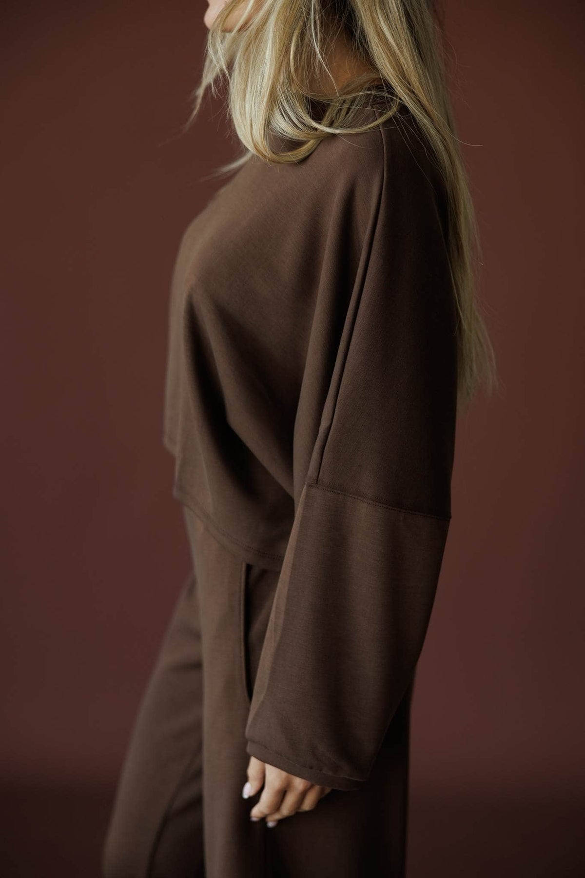 Cropped Scuba Dolman Top in brown, side view showing the wide dolman sleeve