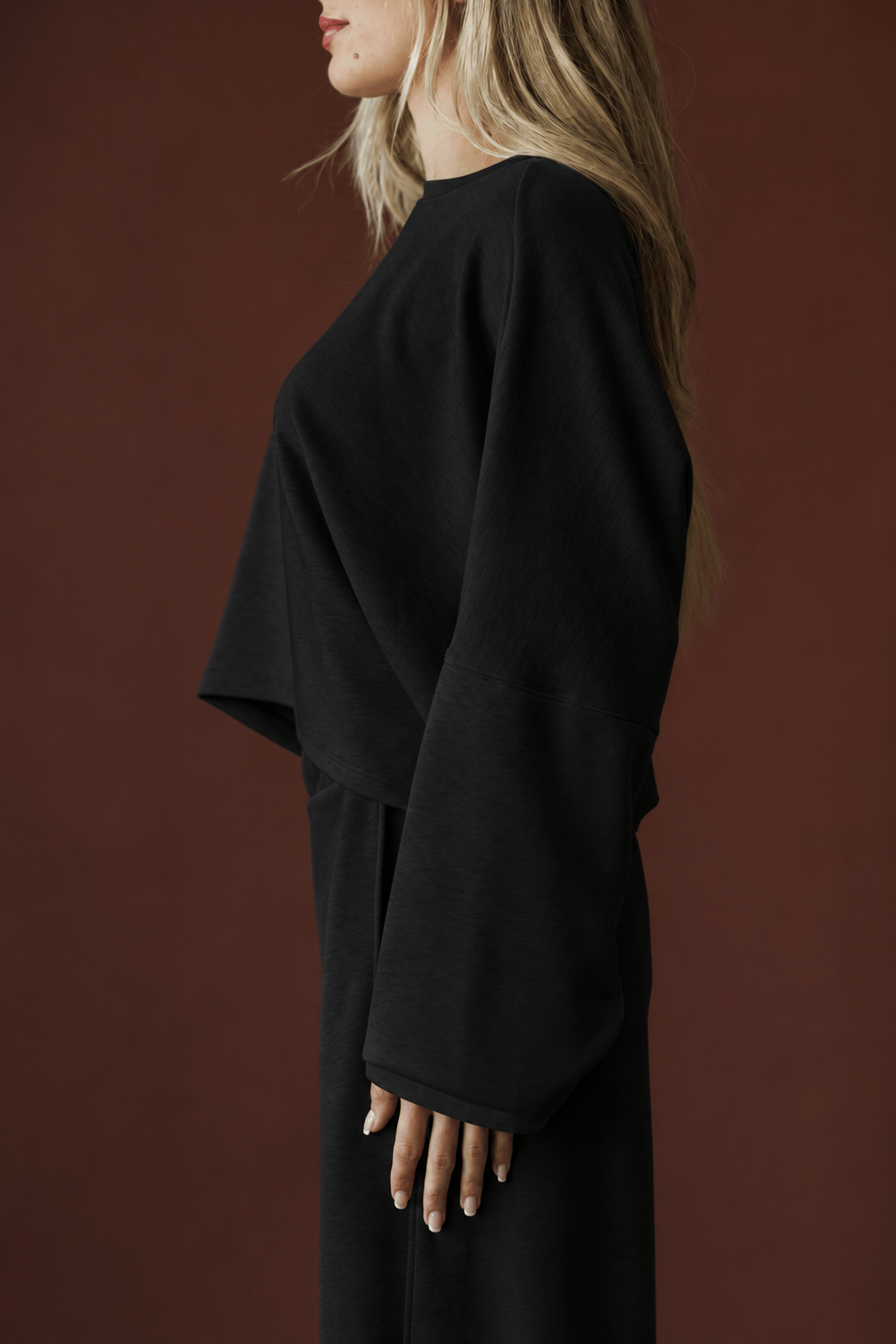 Cropped Scuba Dolman Top in black, side view showing the wide dolman sleeve
